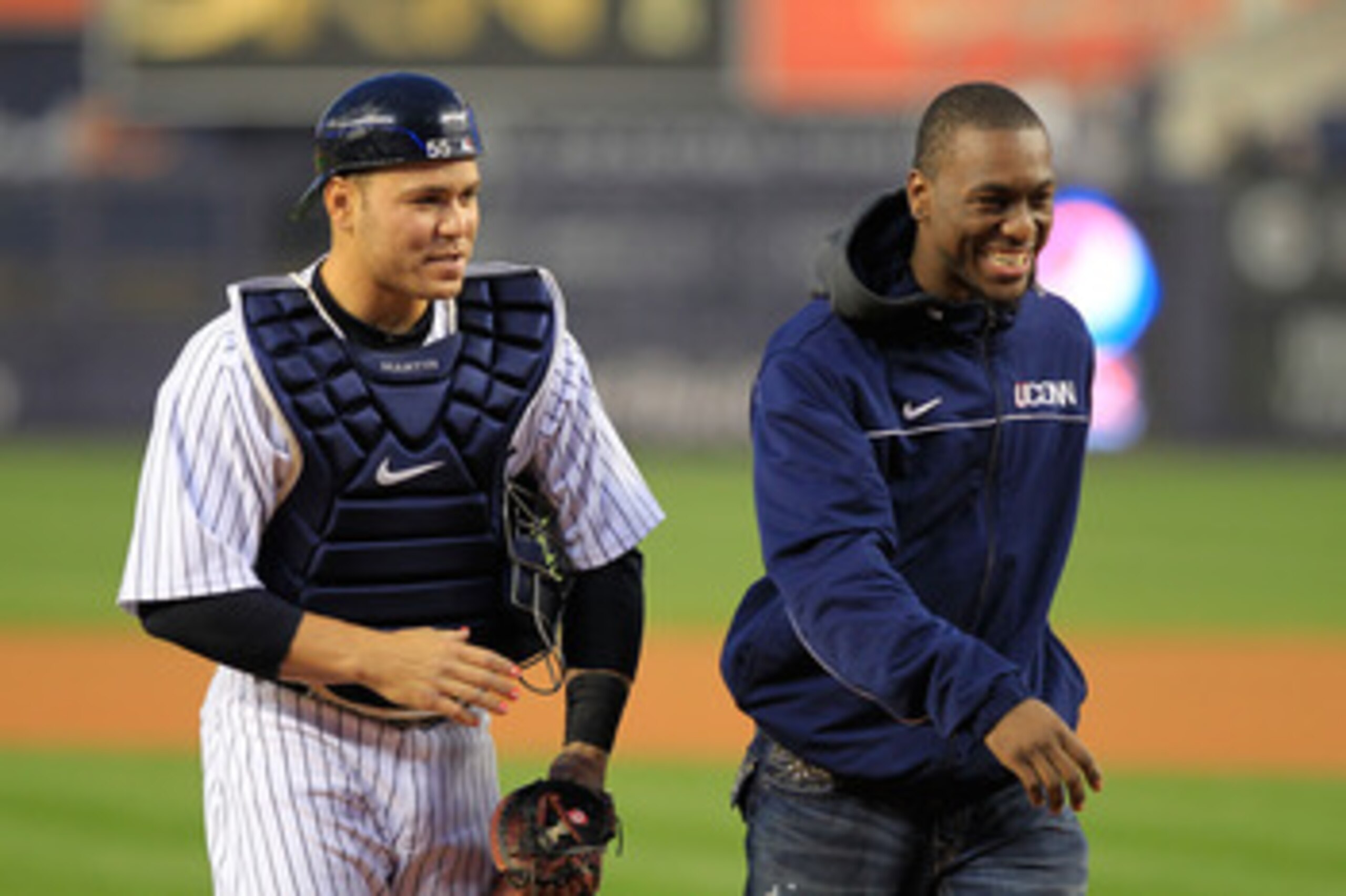 NEW YORK, NY - APRIL 13: Kemba Walker (R), guard for the Connecticut Huskies walks with Russell Martin #55 of the New York Yankees after he throws out the first pitch before the game between the New York Yankees and the Baltimore Orioles at Yankee Stadium