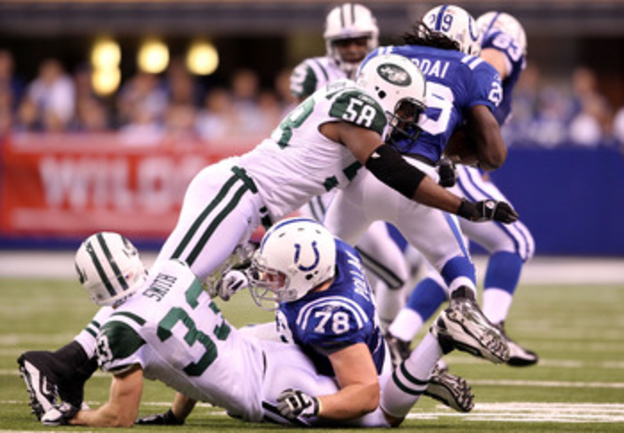 INDIANAPOLIS, IN - JANUARY 08:  Bryan Thomas #58 of the New York Jets tackles Joseph Addai #29 of the Indianapolis Colts during their 2011 AFC wild card playoff game at Lucas Oil Stadium on January 8, 2011 in Indianapolis, Indiana. The Jets won 17-16. (Ph