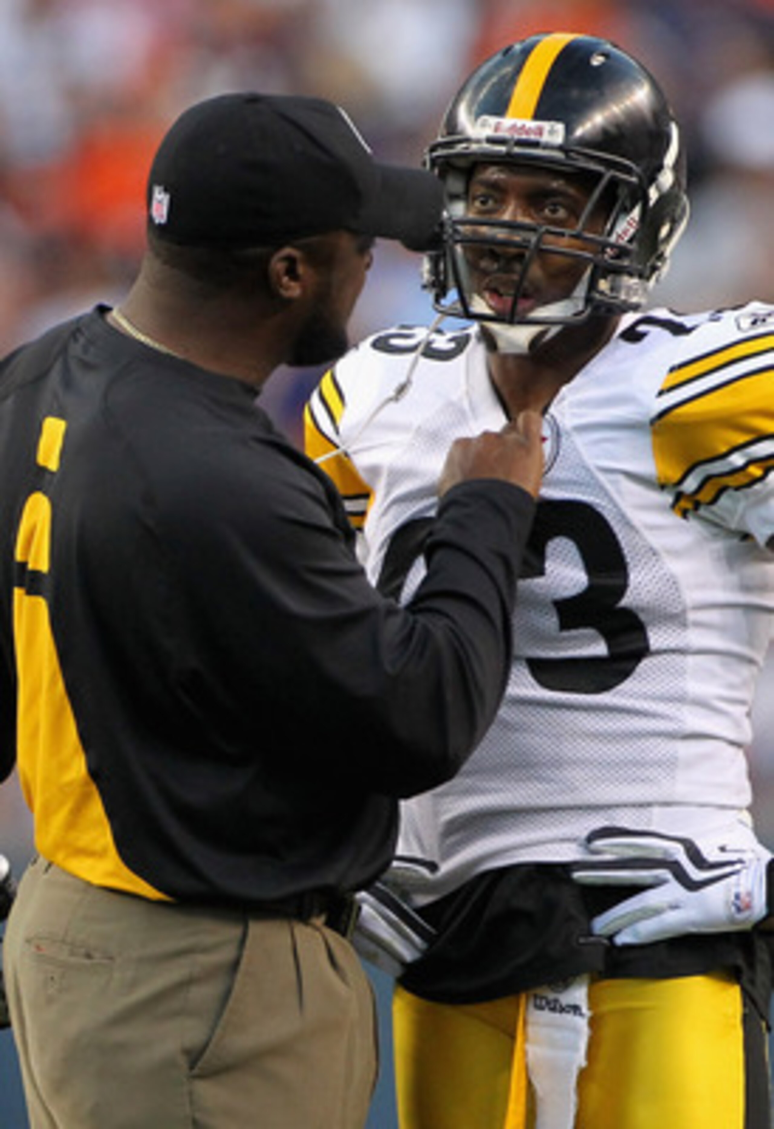 DENVER - AUGUST 29:  Head coach Mike Tomlin of the Pittsburgh Steelers has something to say to cornerback Keenan Lewis #23 after he was called for a personal foul as he tackled Brandon Lloyd of the Denver Broncos during preseason NFL action at INVESCO Fie