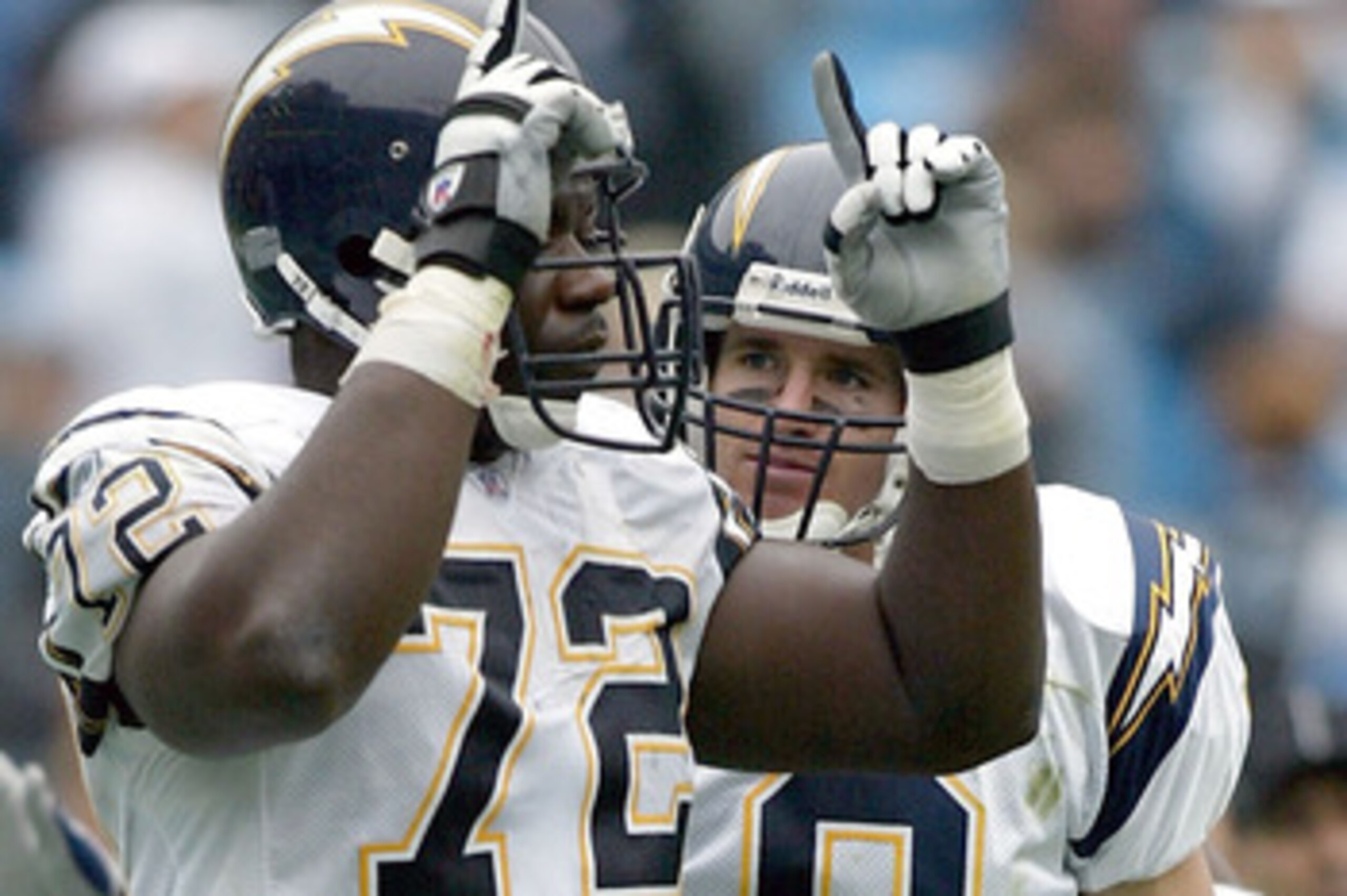 CHARLOTTE, NC - OCTOBER 24:  Drew Brees #9 of the San Diego Chargers celebrates with teammate Roman Oben #72 after a touchdown during their game against the Carolina Panthers on October 24, 2004 at Bank of America Stadium in Charlotte, North Carolina. (Ph