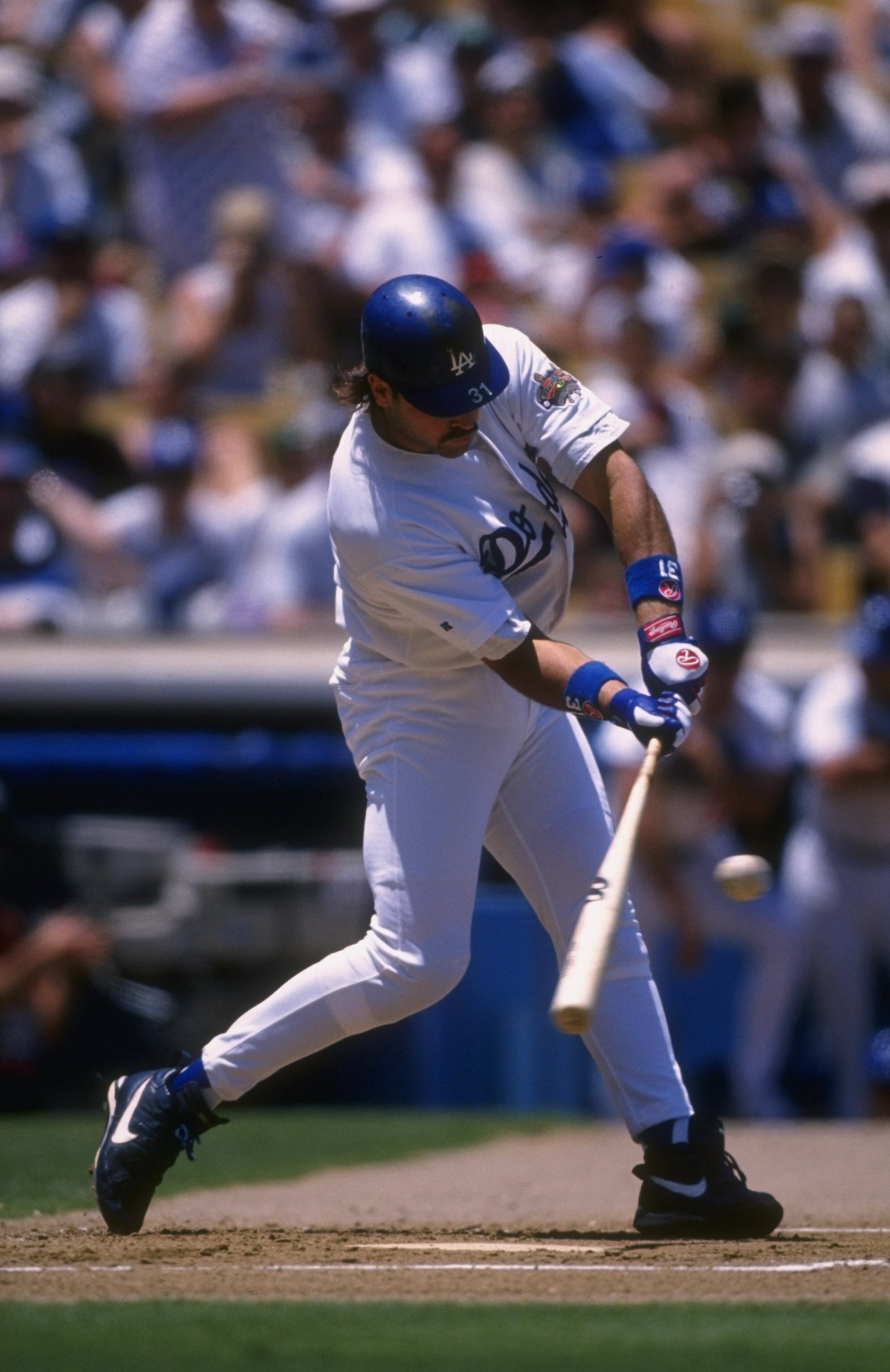 8 Jul 1996:  Catcher Mike Piazza of the Los Angeles Dodgers focuses on the ball as he begins his swing during an at-bat in the Dodgers 3-0 loss to the Colorado Rockies at Dodger Stadium in Los Angeles, California.  Mandatory Credit: Jed Jacobsoh  /Allspor