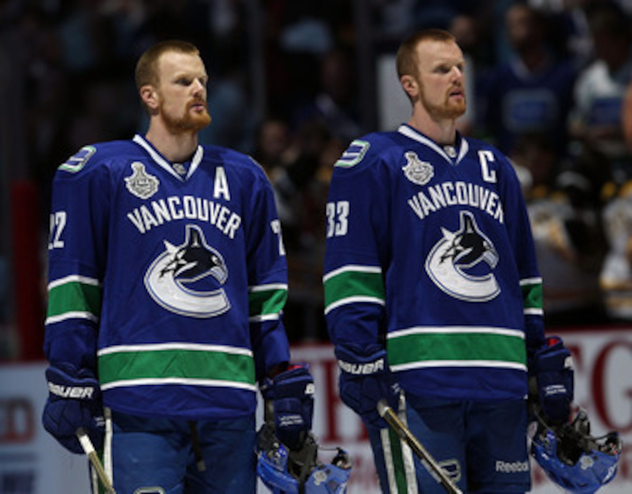 VANCOUVER, BC - JUNE 10:  Daniel Sedin #22 and Henrik Sedin #33 of the Vancouver Canucks look on prior to Game Five of the 2011 NHL Stanley Cup Final at Rogers Arena on June 10, 2011 in Vancouver, British Columbia, Canada.  (Photo by Bruce Bennett/Getty I