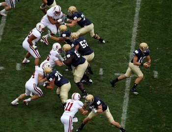 SOUTH BEND, IN - SEPTEMBER 25: Dayne Crist #10 of the Notre Dame Fighting Irish turns to hand-off as his offensive line blocks against the Stanford Cardinal defense at Notre Dame Stadium on September 25, 2010 in South Bend, Indiana. Standford defeated Not