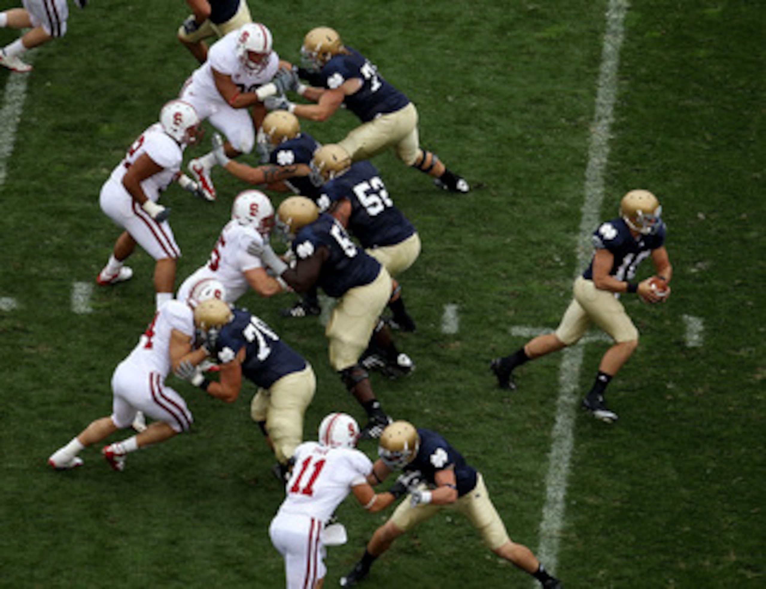 SOUTH BEND, IN - SEPTEMBER 25: Dayne Crist #10 of the Notre Dame Fighting Irish turns to hand-off as his offensive line blocks against the Stanford Cardinal defense at Notre Dame Stadium on September 25, 2010 in South Bend, Indiana. Standford defeated Not