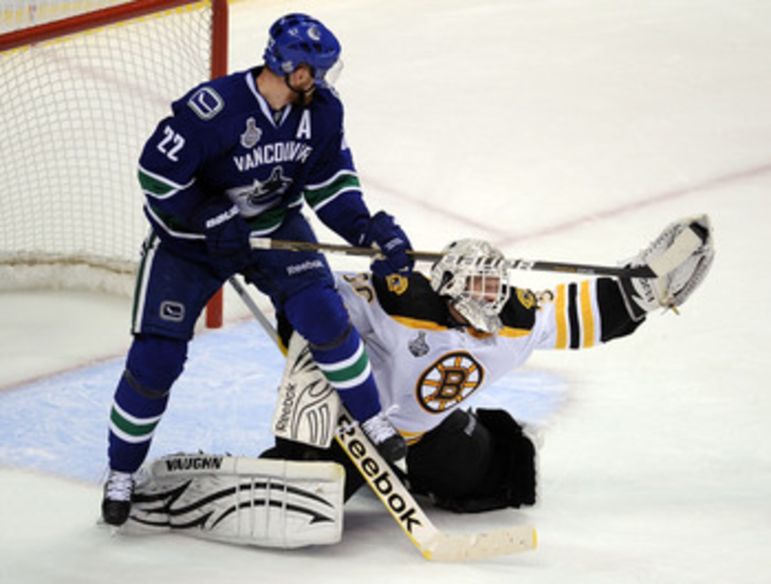 VANCOUVER, BC - JUNE 10:  Tim Thomas #30 of the Boston Bruins makes a glove save against Manny Malhotra #27 of the Vancouver Canucks during Game Five of the 2011 NHL Stanley Cup Final at Rogers Arena on June 10, 2011 in Vancouver, British Columbia, Canada