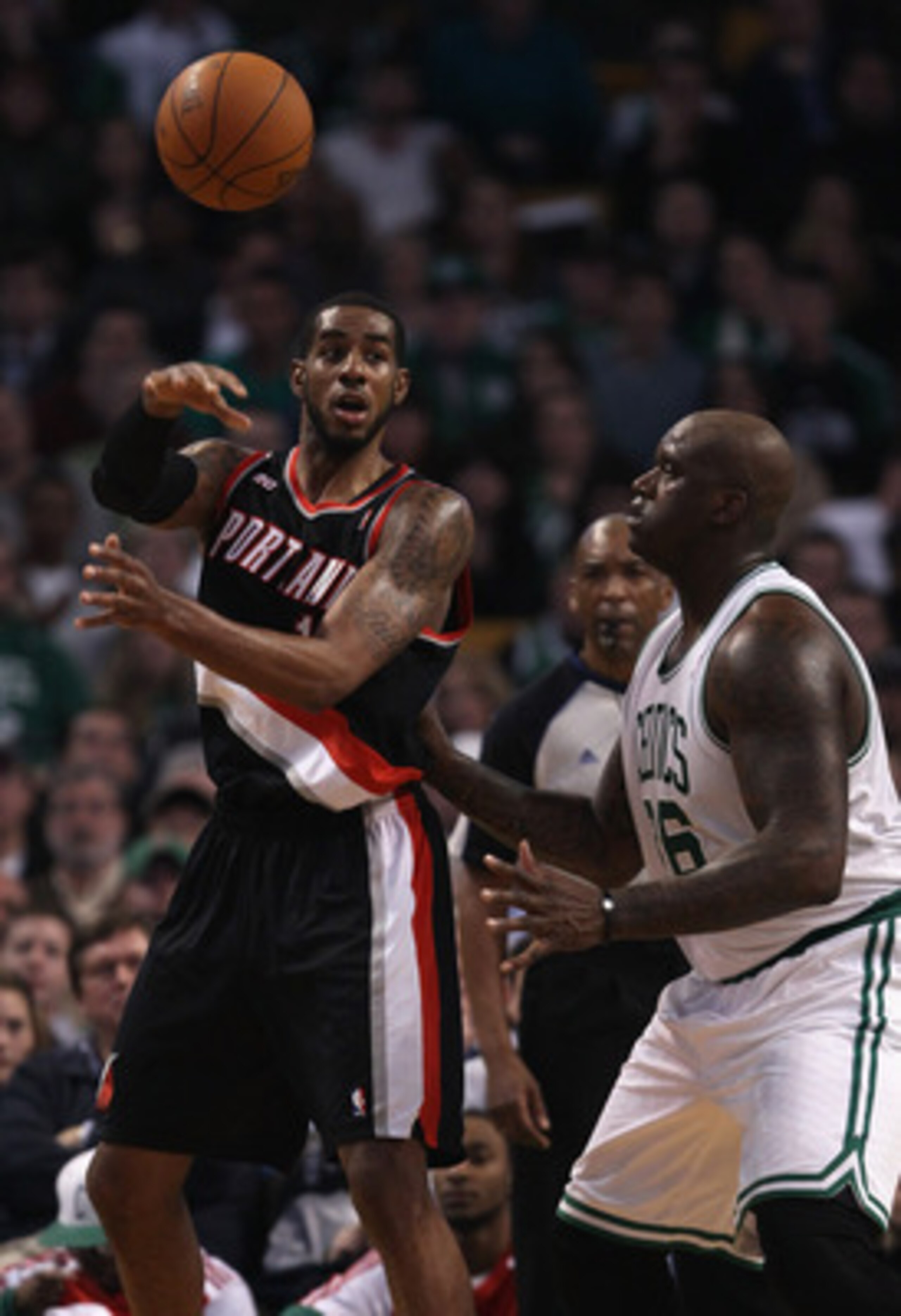 BOSTON - DECEMBER 01:  LaMarcus Aldridge #12 of the Portland Trailblazers passes the ball under pressure from Shaquille O'Neal #36 of the Boston Celtics on December 1, 2010 at the TD Garden in Boston, Massachusetts.  NOTE TO USER: User expressly acknowled
