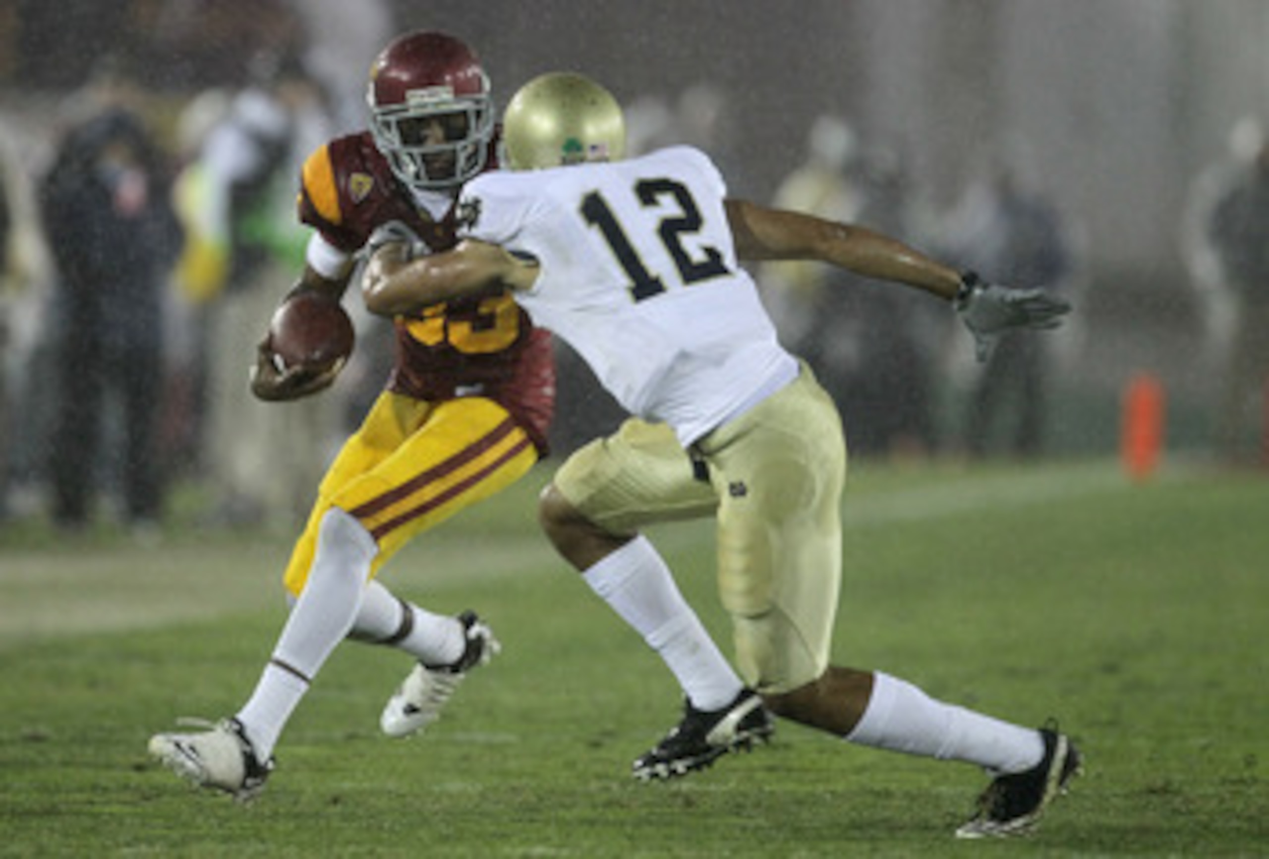 LOS ANGELES, CA - NOVEMBER 27:  Wide receiver Ronald Johsnon #83 of the USC Trojans carries the ball against cornerback Robert Blanton #12 of the Notre Dame Fighting Irish at the Los Angeles Memorial Coliseum on November 27, 2010 in Los Angeles, Californi