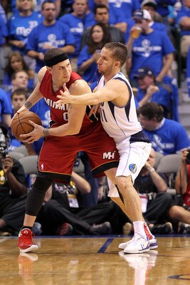 DALLAS, TX - JUNE 07:  Mike Bibby #0 of the Miami Heat looks to pass against Jose Juan Barea #11 of the Dallas Mavericks in Game Four of the 2011 NBA Finals at American Airlines Center on June 7, 2011 in Dallas, Texas. The Mavericks won 86-83. NOTE TO USE