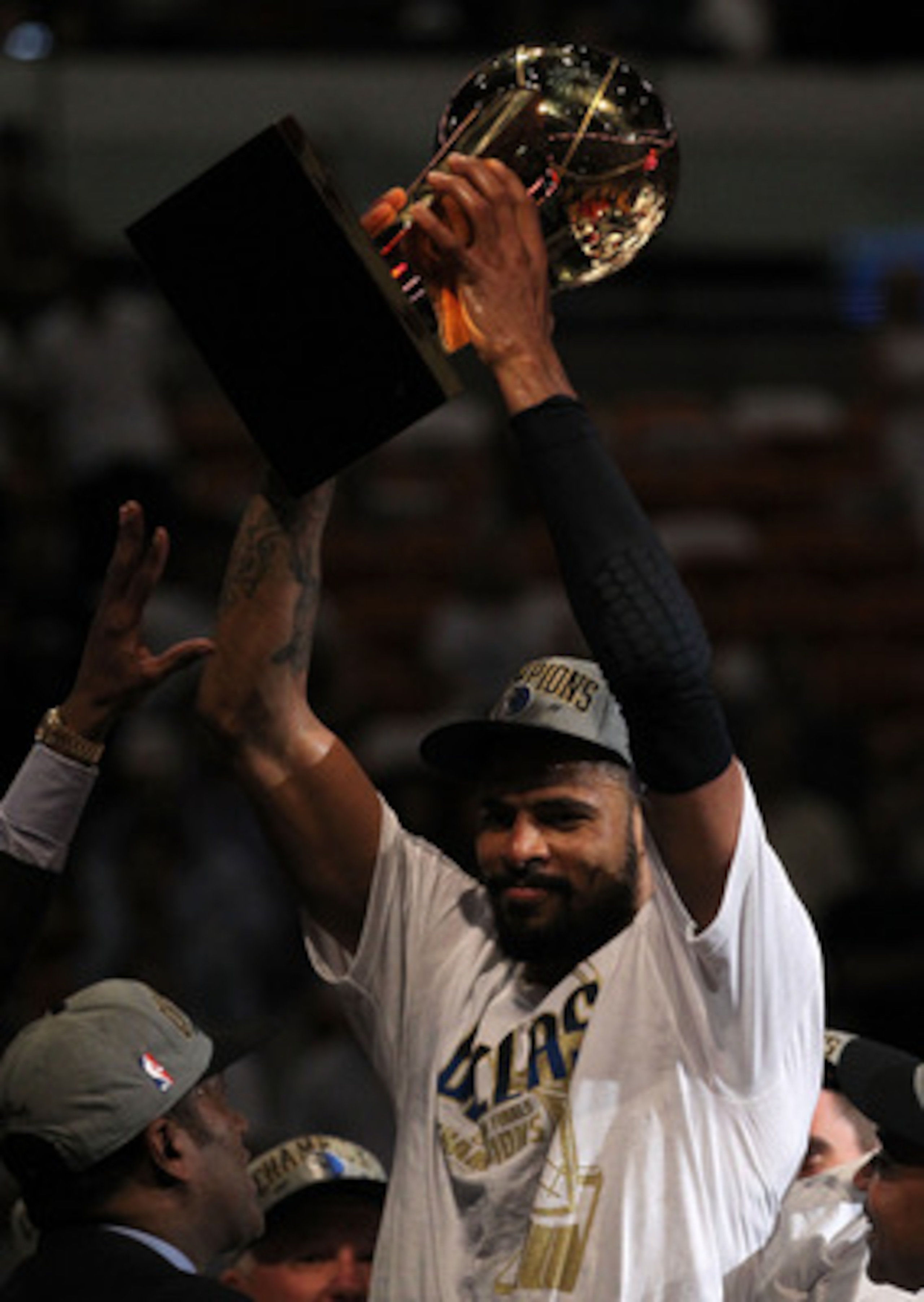 MIAMI, FL - JUNE 12: Tyson Chandler #6 of the Dallas Mavericks celebrates with the Larry O'Brien trophy after the Mavericks won 105-95 against the Miami Heat in Game Six of the 2011 NBA Finals at American Airlines Arena on June 12, 2011 in Miami, Florida MIAMI, FL - JUNE 12: Tyson Chandler #6 of the Dallas Mavericks celebrates with the Larry O'Brien trophy after the Mavericks won 105-95 against the Miami Heat in Game Six of the 2011 NBA Finals at American Airlines Arena on June 12, 2011 in Miami, Florida