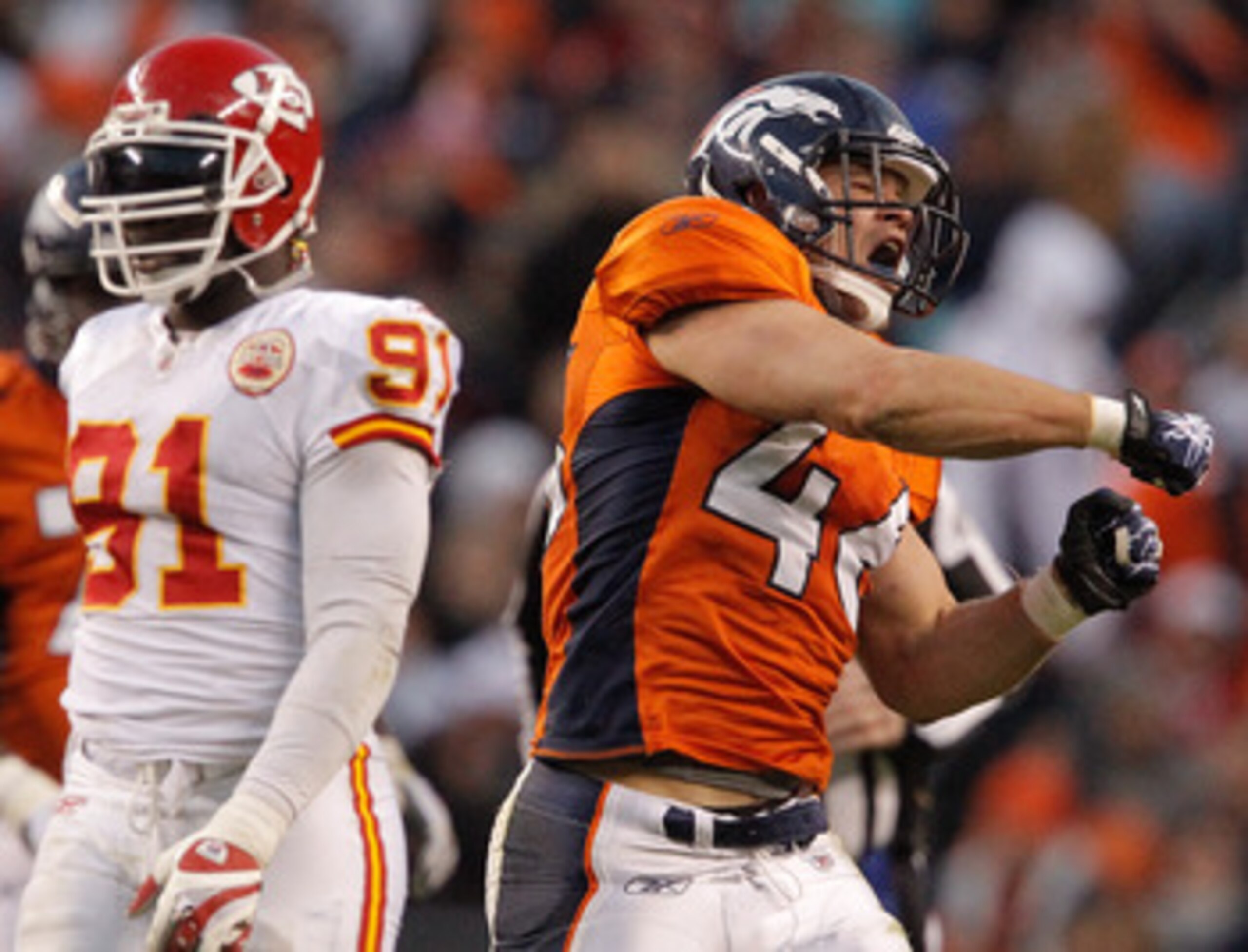 DENVER - NOVEMBER 14:  Full back Spencer Larsen #46 of the Denver Broncos celebrates a run for a first down as linebacker Tamba Hali #91 of the Kansas City Chiefs looks on during the third quarter at INVESCO Field at Mile High on November 14, 2010 in Denv