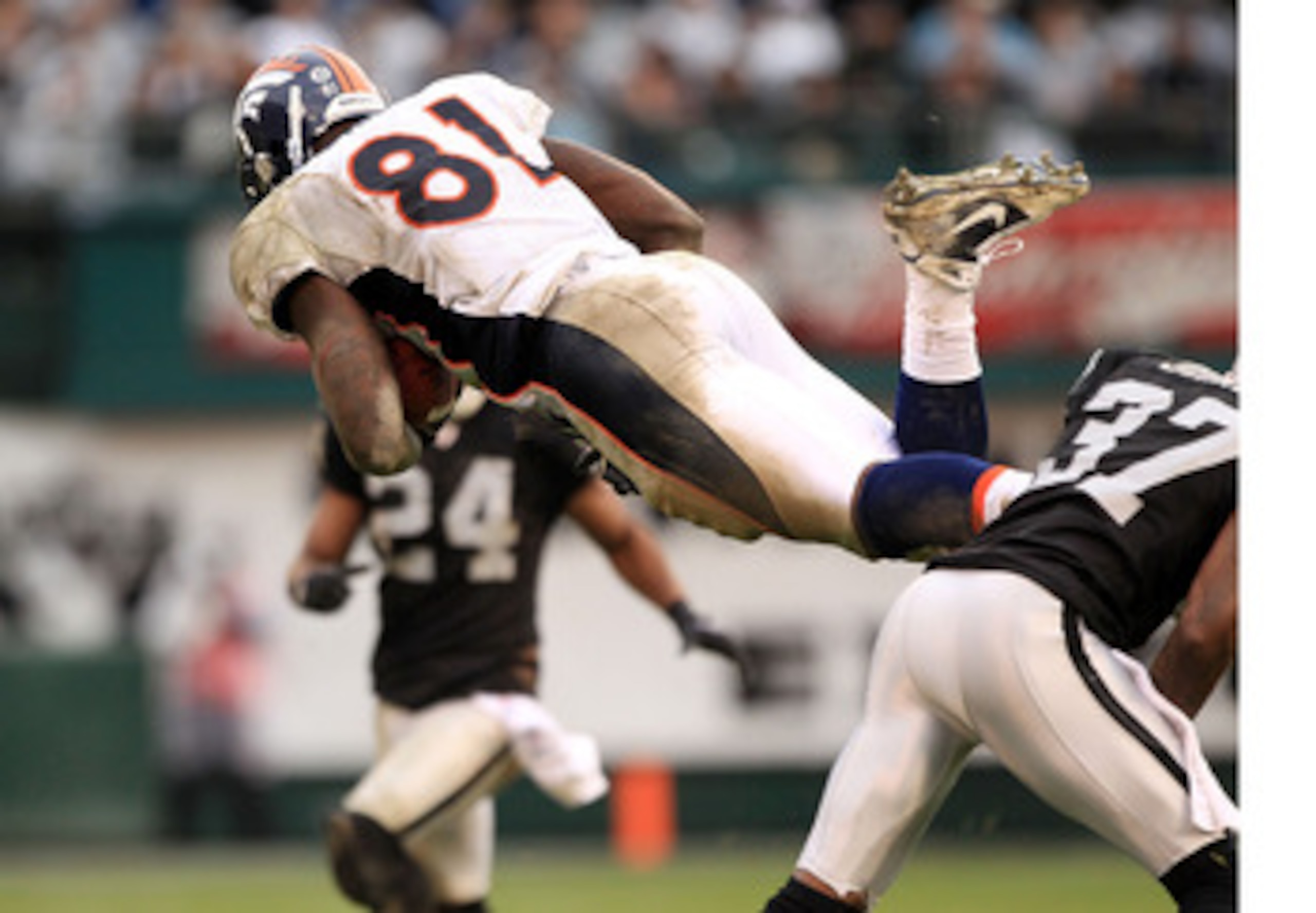 OAKLAND, CA - DECEMBER 19:  Richard Quinn #81 of the Denver Broncos goes airborne after being hit during their game against the Oakland Raiders at Oakland-Alameda County Coliseum on December 19, 2010 in Oakland, California.  (Photo by Ezra Shaw/Getty Imag