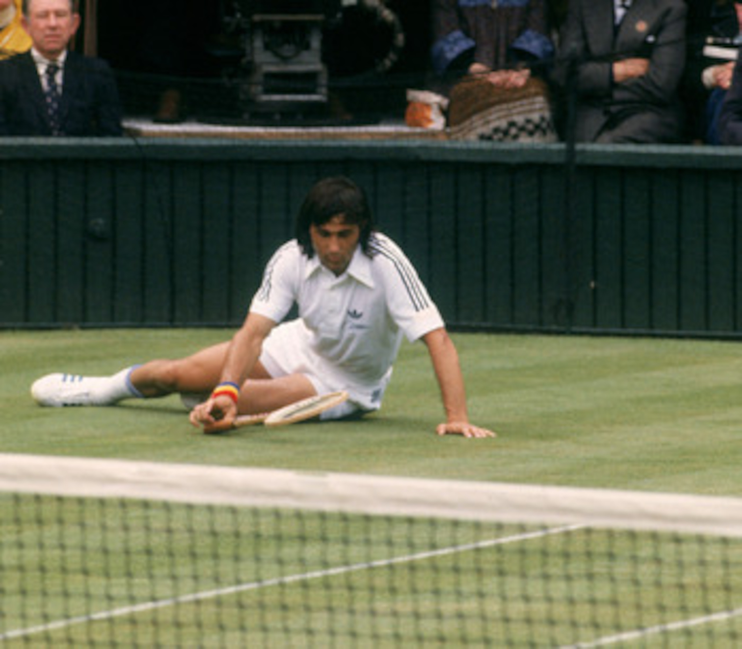 Romanian tennis player Ilie Nastase during a match against Tom Okker at Wimbledon, 1977. (Photo by Tony Duffy/Getty Images)