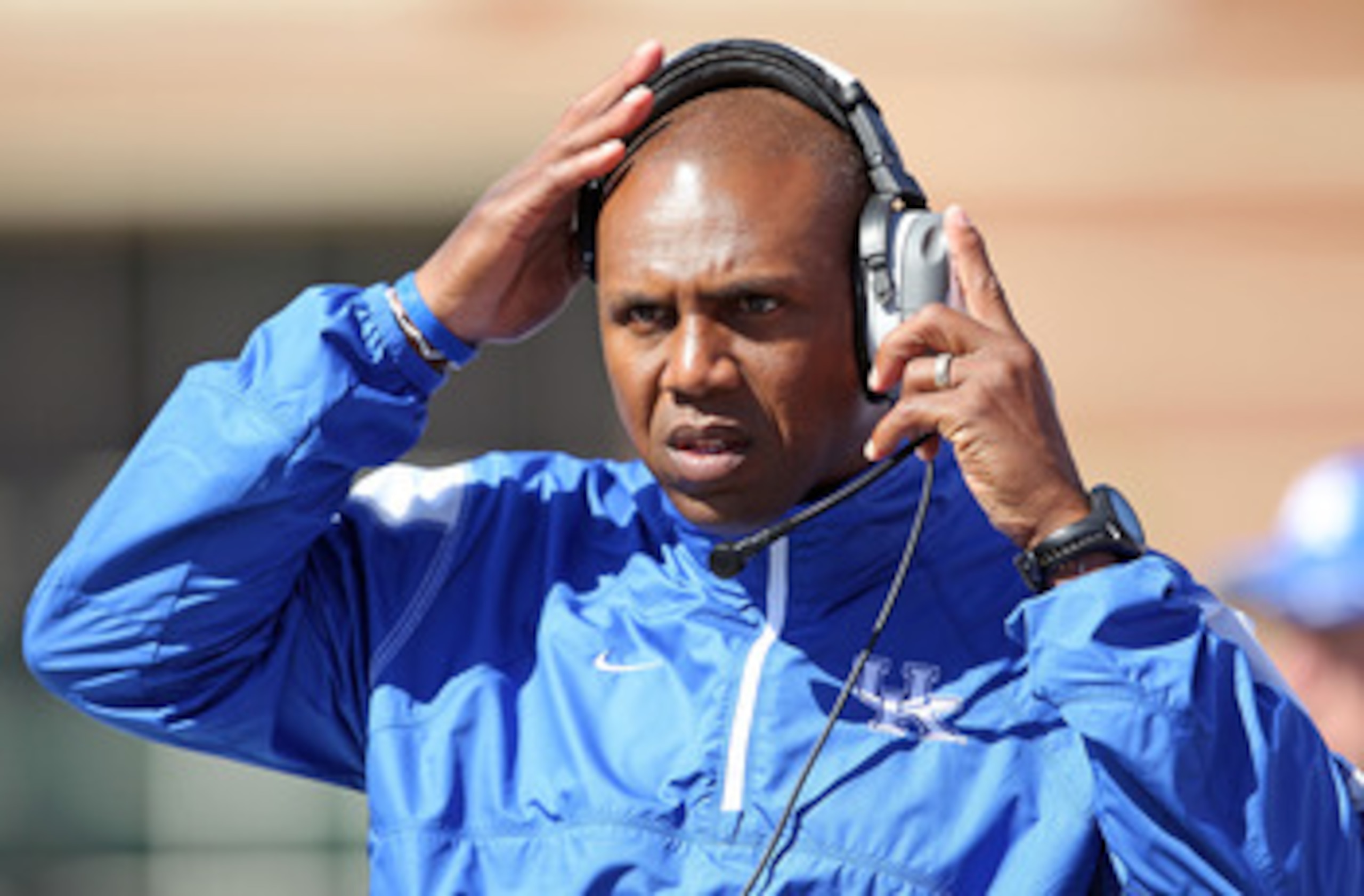 LOUISVILLE, KY - SEPTEMBER 04:  Joker Phillips the Head Coach of the Kentucky Wildcats gives instructions to his team during the game against the Louisville Cardinals at Papa John's Cardinal Stadium on September 4, 2010 in Louisville, Kentucky.  (Photo by