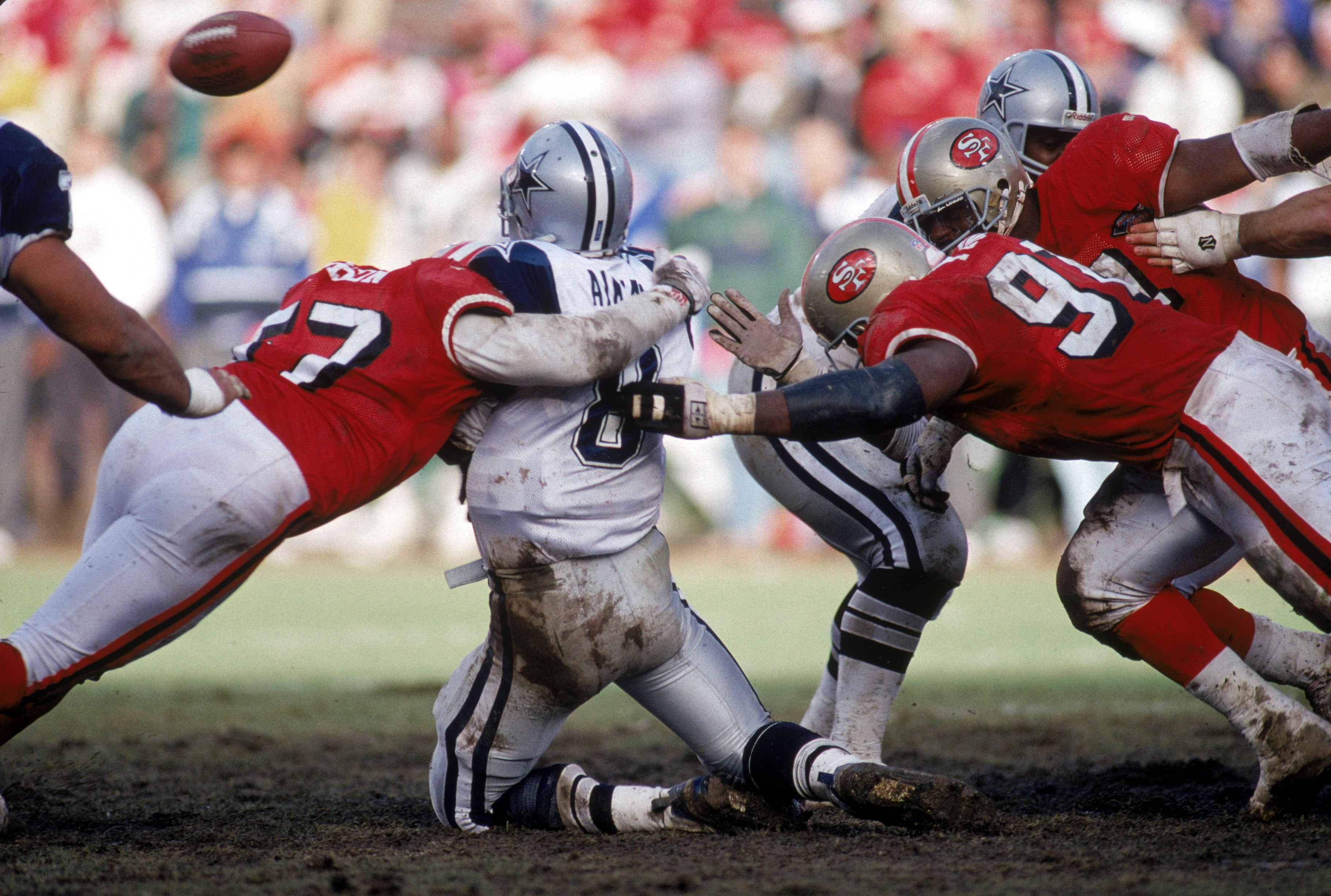 SAN FRANCISCO - JANUARY 15:  Linebacker Rickey Jackson #57 and defensive tackle Dana Stubblefield #94 of the San Francisco 49ers team up to sack Dallas Cowboys quarterback Troy Aikman #8 during the 1994 NFC Championship game at Candlestick Park on January