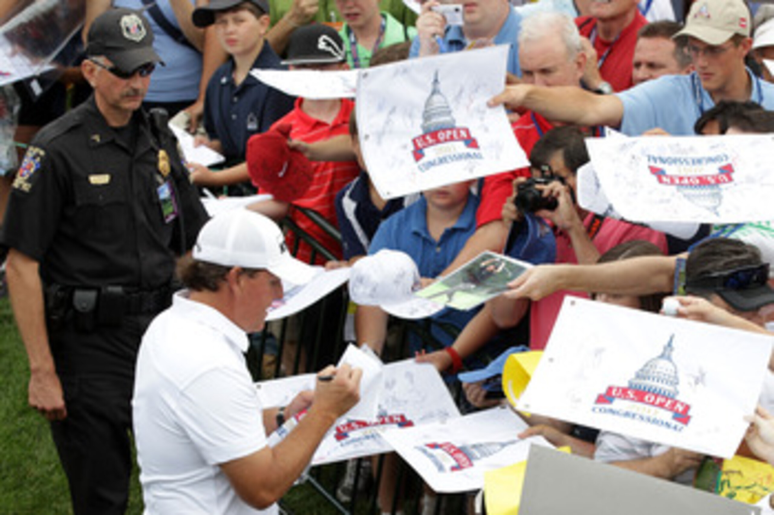 BETHESDA, MD - JUNE 14: Phil Mickelson signs autographs for fans during a practice round prior to the start of the 111th U.S. Open at Congressional Country Club on June 14, 2011 in Bethesda, Maryland. (Photo by Ross Kinnaird/Getty Images) BETHESDA, MD - JUNE 14: Phil Mickelson signs autographs for fans during a practice round prior to the start of the 111th U.S. Open at Congressional Country Club on June 14, 2011 in Bethesda, Maryland. (Photo by Ross Kinnaird/Getty Images)