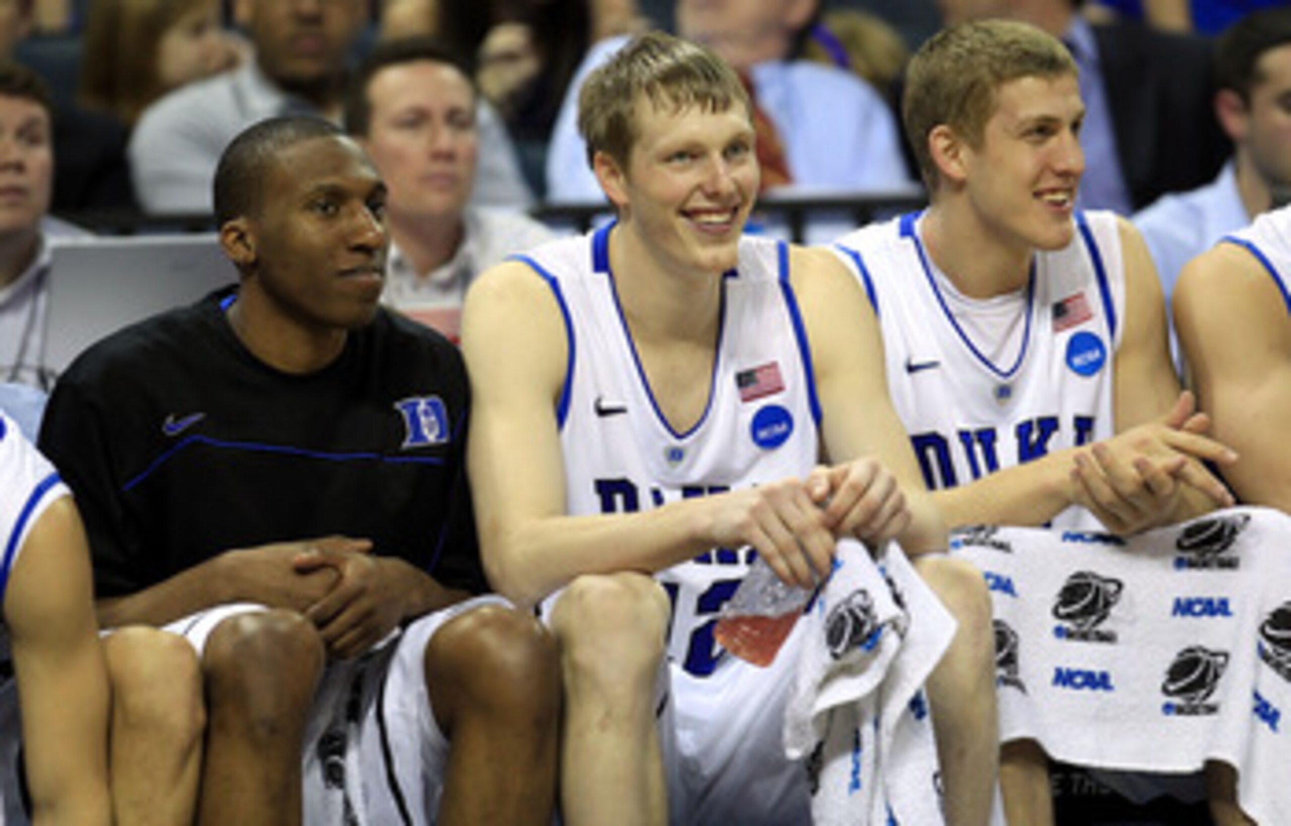 CHARLOTTE, NC - MARCH 18:  (L-R) Nolan Smith #2, Kyle Singler #12 and Mason Plumlee #5 of the Duke Blue Devils sit on the bench in the second half while taking on the Hampton Pirates during the second round of the 2011 NCAA men's basketball tournament at