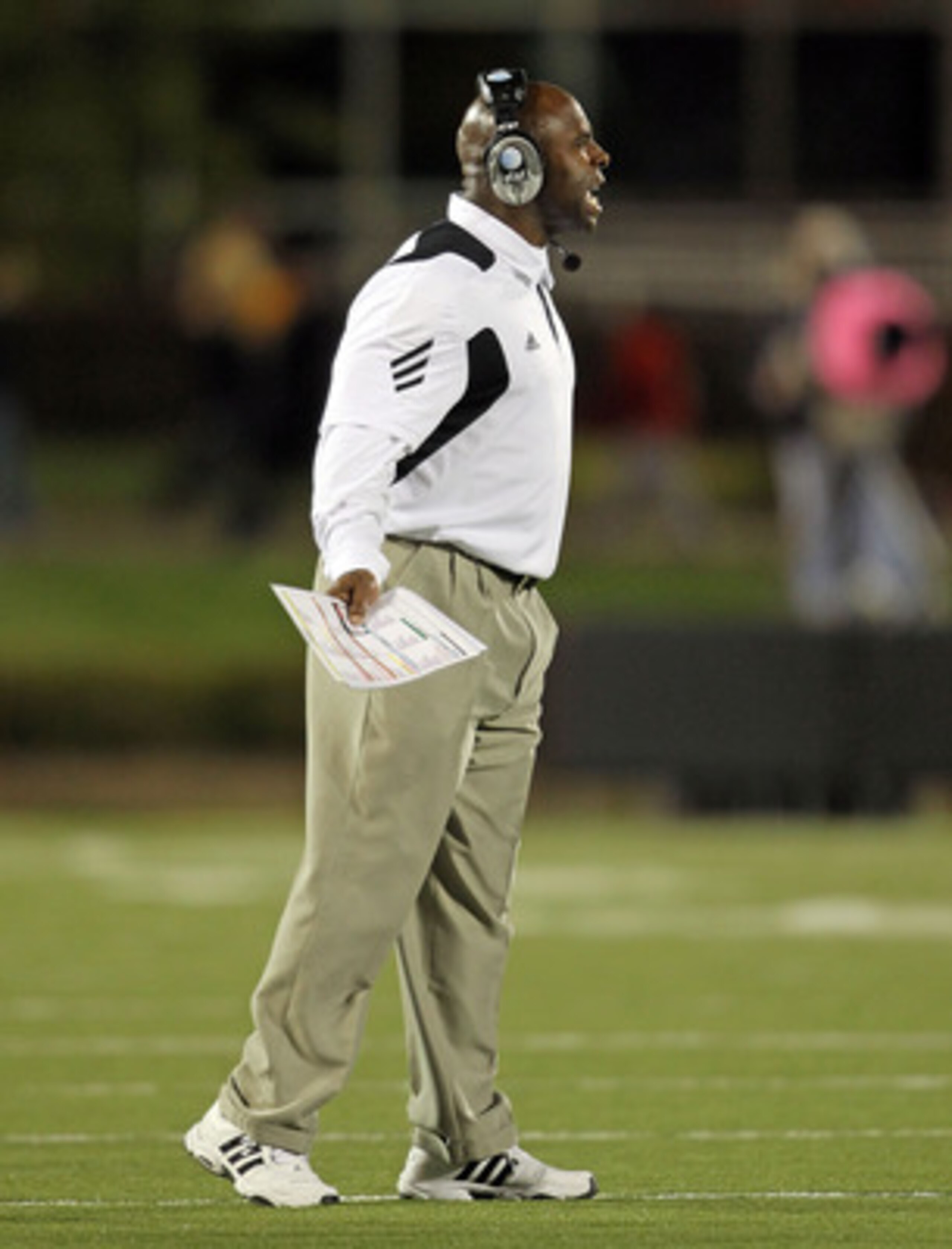 LOUISVILLE, KY - OCTOBER 15: Charlie Strong the Haed Coach of the Louisville Cardinals gives instructions to his team during the Big East Conference game against the Cincinnati Bearcats at Papa John's Cardinal Stadium on October 15, 2010 in Louisville, Ke