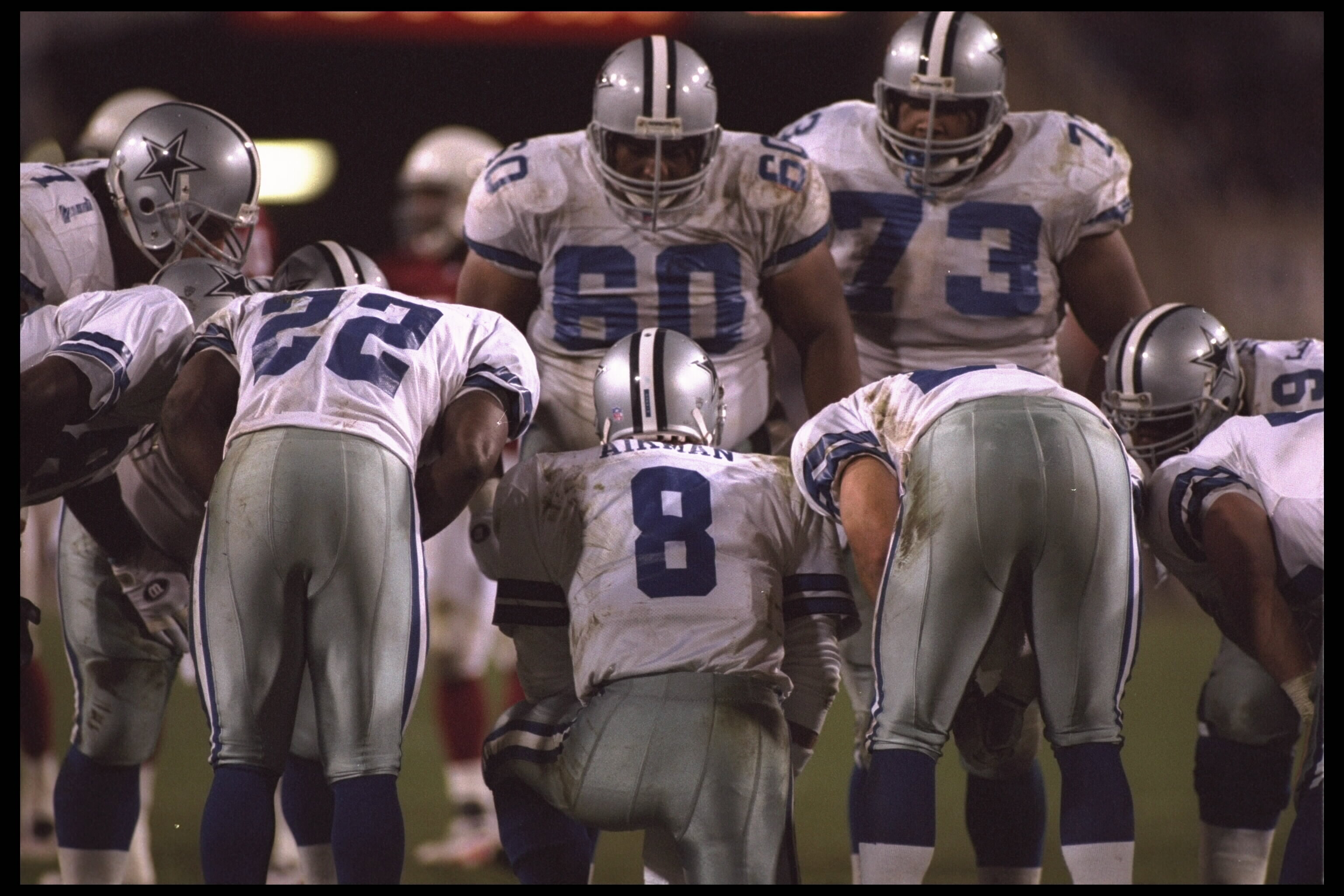 25 Dec 1995:  Quarterback Troy Aikman #8 of the Dallas Cowboys huddles up with the team and explains the play against the Arizona Cardinals at Sun Devil Stadium in Tempe, Arizona.  The Cowboys defeated the Cardinals 37-13.  Mandatory Credit:  Jamie Squire