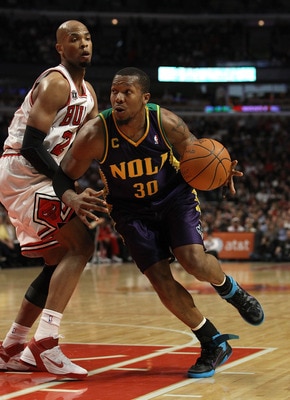 CHICAGO, IL - MARCH 07: David West #30 of the New Orleans Hornets moves against Taj Gibson #22 of the Chicago Bulls at the United Center on March 7, 2011 in Chicago, Illinois. The Bulls defeated the Hornets 85-77. NOTE TO USER: User expressly acknowledges