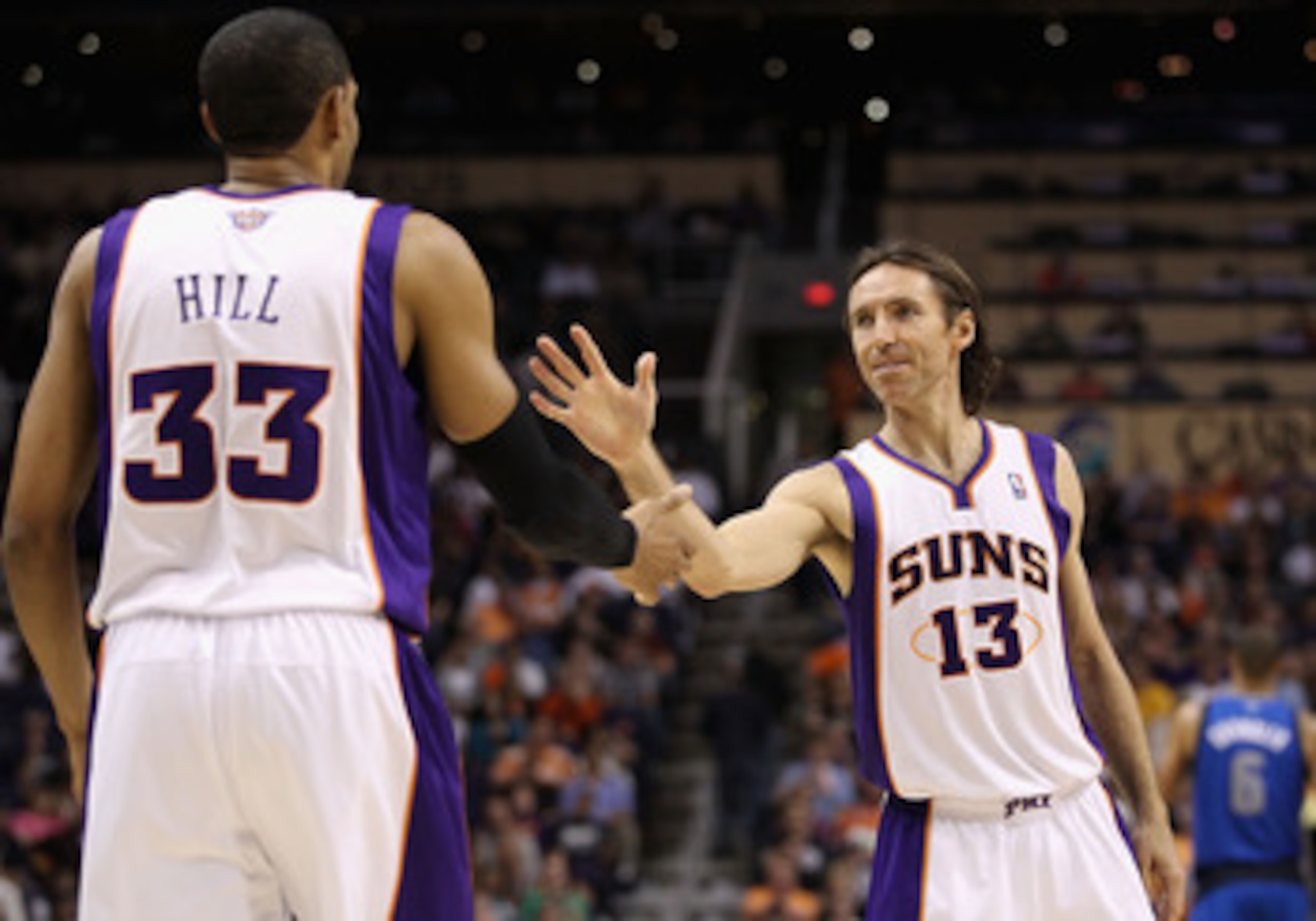 PHOENIX, AZ - MARCH 27:  Steve Nash #13 of the Phoenix Suns high fives teammate Grant Hill #33 during the NBA game against the Dallas Mavericks at US Airways Center on March 27, 2011 in Phoenix, Arizona. The Mavericks defeated the Suns 91-83.  NOTE TO USE