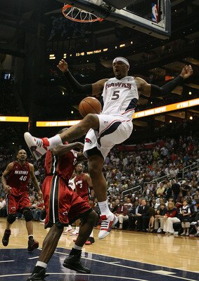 ATLANTA - MAY 03:  Josh Smith #5 of the Atlanta Hawks celebrates celebrates after dunking over Joel Anthony #50 of the Miami Heat during Game Seven of the Eastern Conference Quarterfinals at Philips Arena on May 3, 2009 in Atlanta, Georgia. The Hawks defe