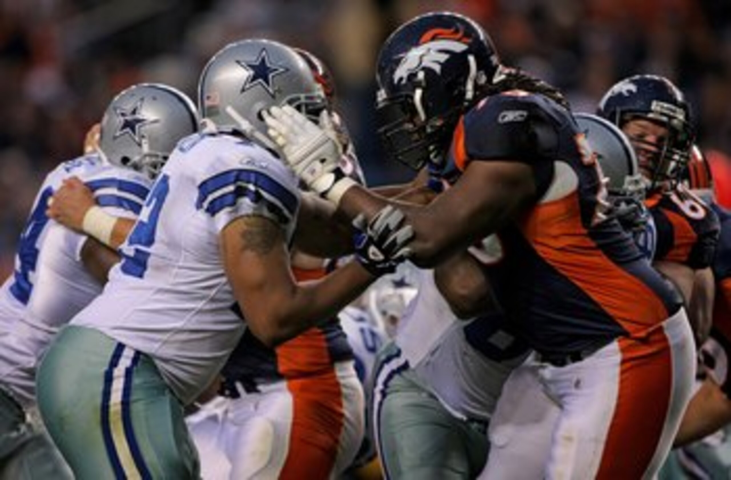 DENVER - AUGUST 16:  Offensive tackle Ryan Clady #78 of the Denver Broncos blocks defensive end Stephen Bowen #72 of the Dallas Cowboys during preseason NFL action at Invesco Field at Mile High on August 16, 2008 in Denver, Colorado. The Broncos defeated