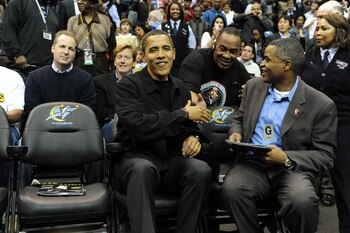 WASHINGTON - FEBRUARY 27:  U.S. President Barack Obama (C) is greeted by fans at an NBA (National Basketball Association) game between the Chicago Bulls and Washington Wizards on February 27, 2009 at the Verizon Center in Washington, DC.  (Photo by Michae