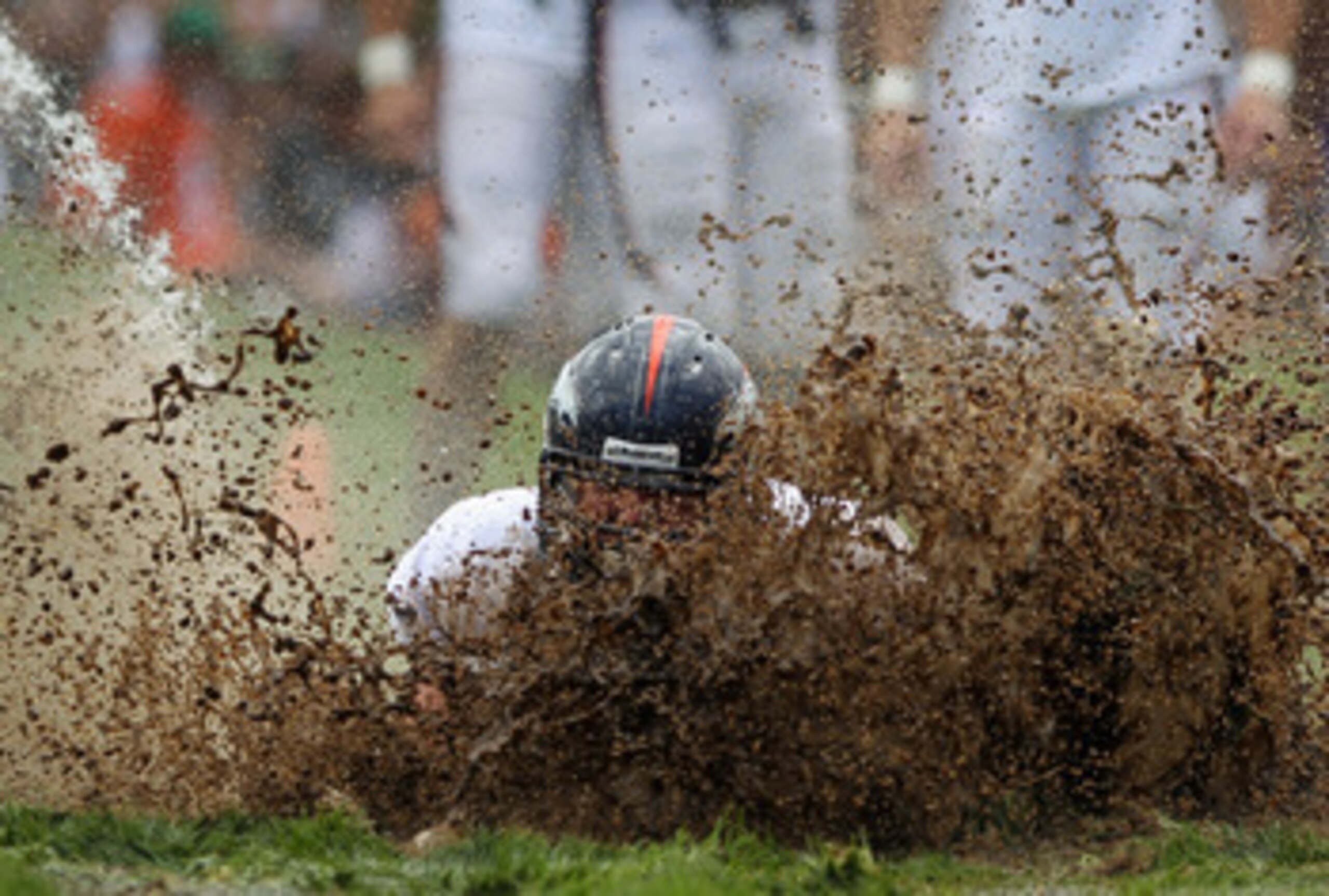 ENGLEWOOD, CO - AUGUST 05:  Zane Beadles #68 of the Denver Broncos dives into the mud as rookies partake in the slip and slide fumble drill during training camp at Dove Valley on August 5, 2010 in Englewood, Colorado.  (Photo by Doug Pensinger/Getty Image