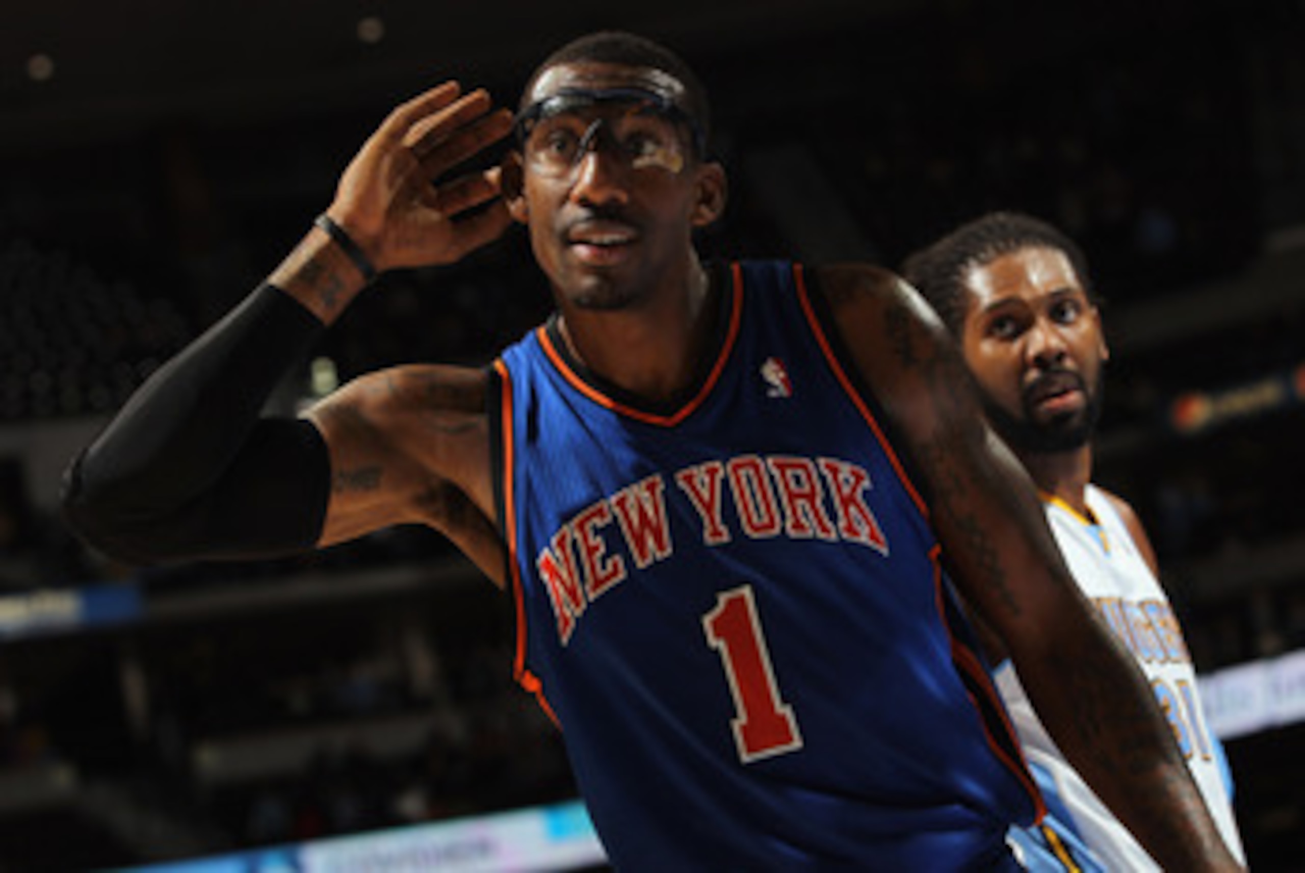 DENVER - NOVEMBER 16:  Amar'e Stoudemire #1 of the New York Knicks holds his hand to his ear as he attempts to engage the home team fans of the Denver Nuggets at the Pepsi Center on November 16, 2010 in Denver, Colorado. NOTE TO USER: User expressly ackno