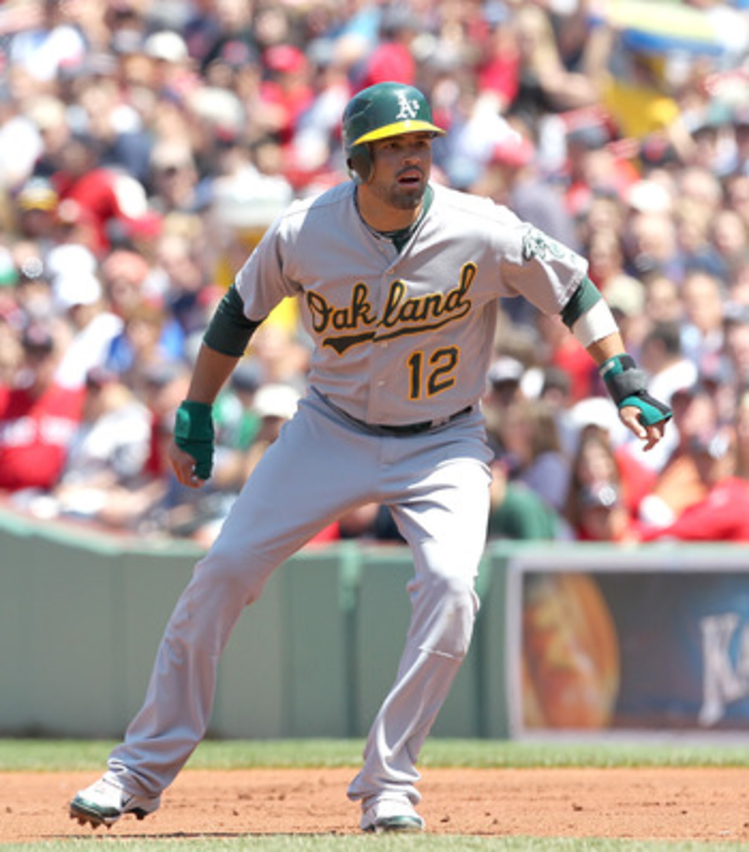 BOSTON, MA - JUNE 5:  David DeJesus #12 of the Oakland Athletics leads off first base against the Boston Red Sox at Fenway Park on June 5, 2011 in Boston, Massachusetts.  (Photo by Jim Rogash/Getty Images)