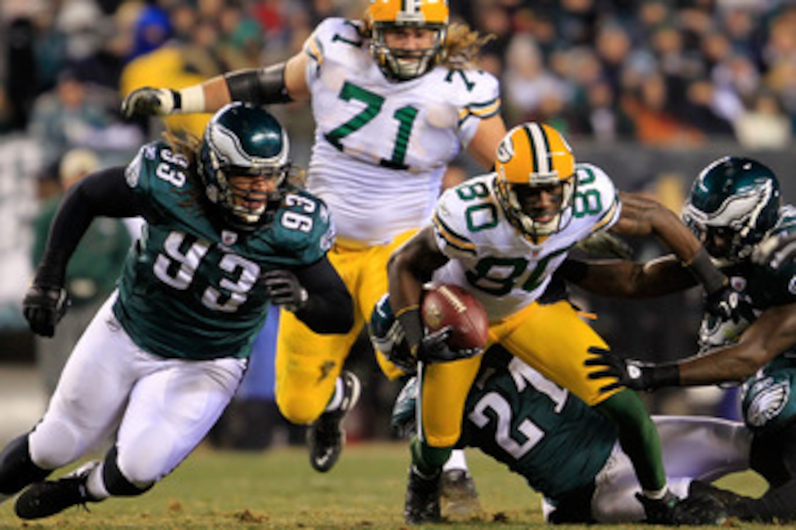 PHILADELPHIA, PA - JANUARY 09:  Donald Driver #80 of the Green Bay Packers tries to avoid the tackle of Trevor Laws #93 Joselio Hanson #21, Jamar Chaney #51 and Keenan Clayton #57 of the Philadelphia Eagles and   during the 2011 NFC wild card playoff game