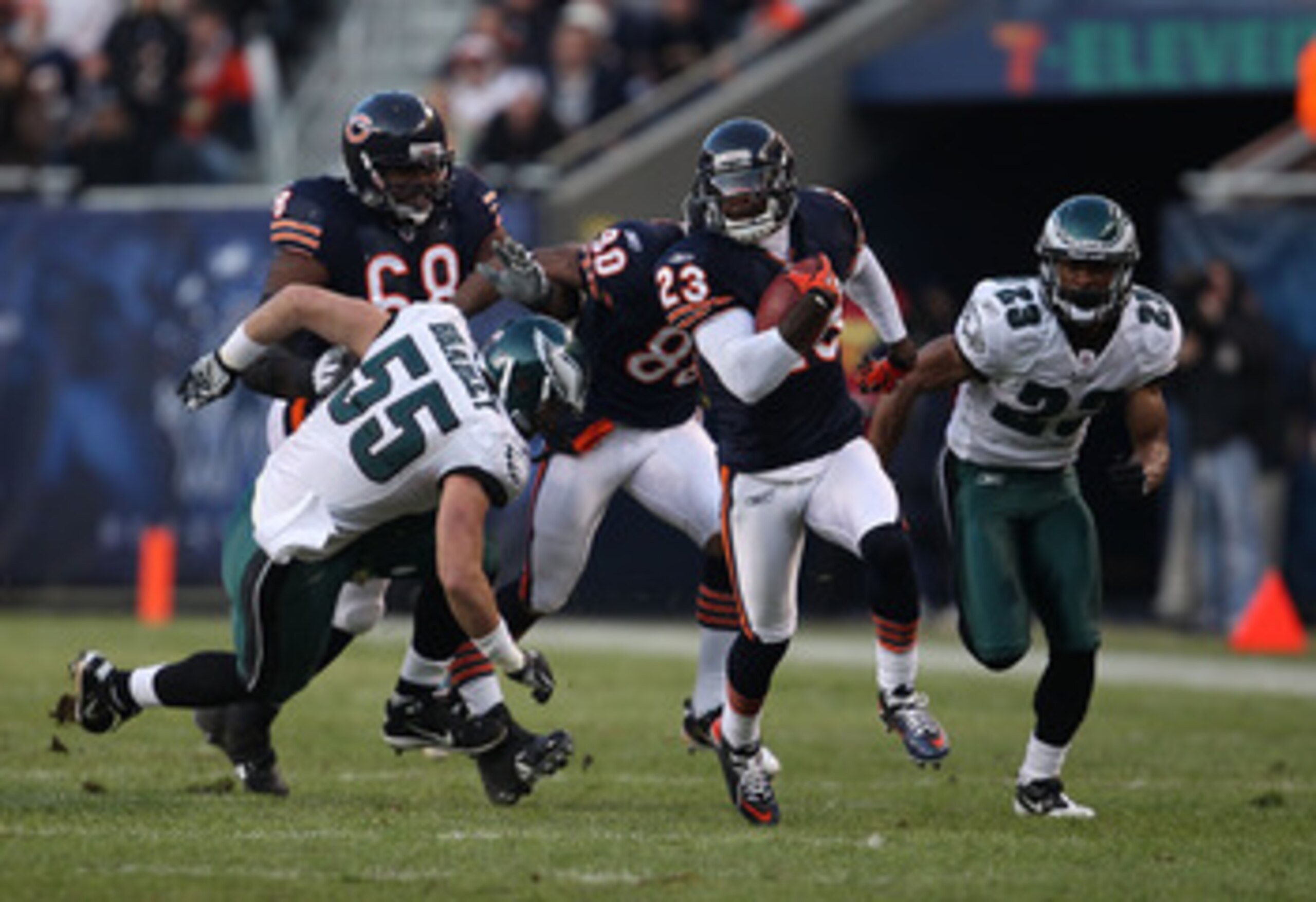 CHICAGO - NOVEMBER 28: Devin Hester #23 of the Chicago Bears breaks for a first down run of 39 yards after a catch pursued by Stewart Bradley #55 and Dimitri Patterson #23 of the Philadelphia Eagles at Soldier Field on November 28, 2010 in Chicago, Illino