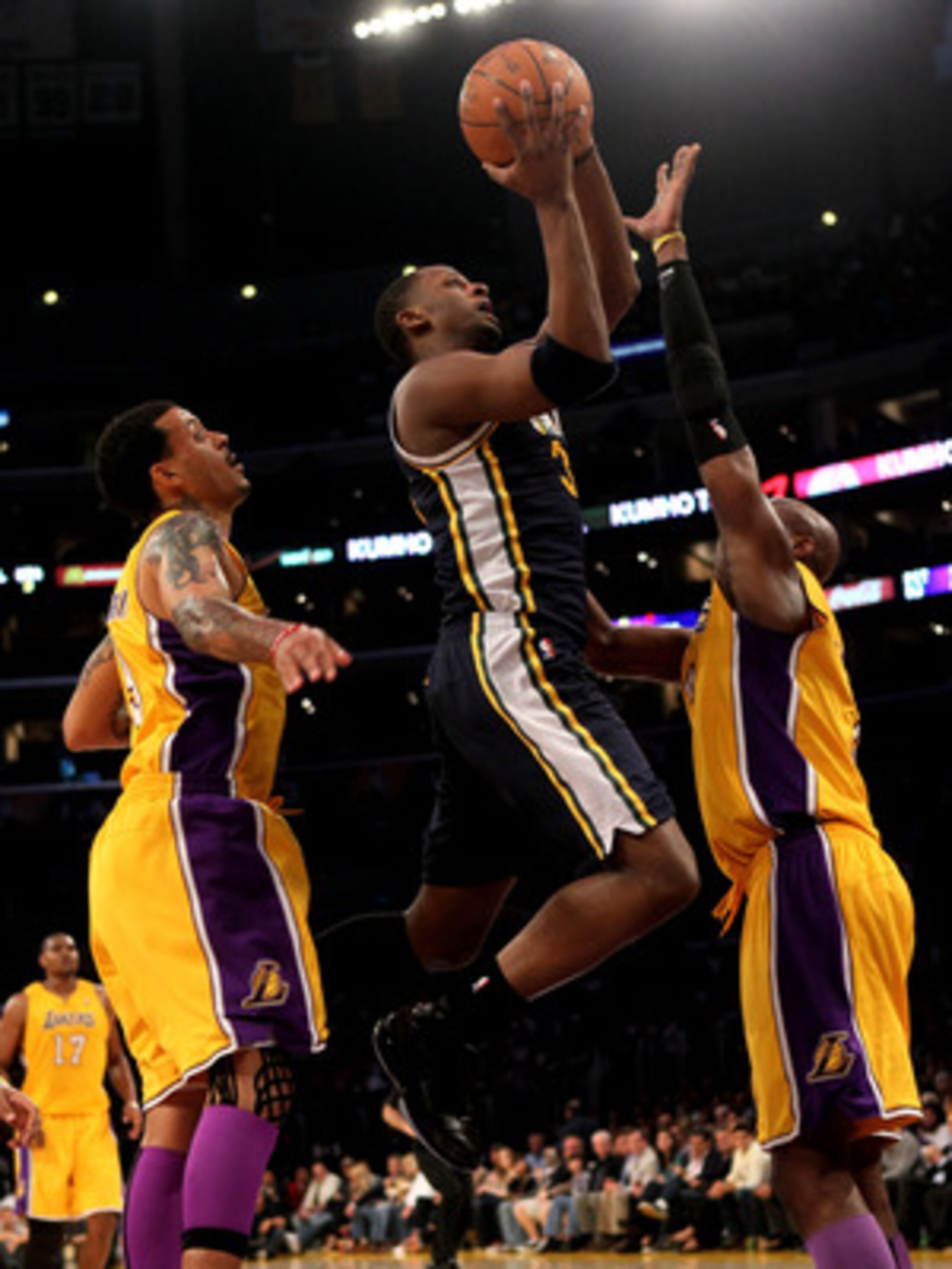 LOS ANGELES, CA - APRIL 05:  C.J. Miles #34 of the Utah Jazz shoots over Kobe Bryant #24 and Matt Barnes #9 of the Los Angeles Lakers at Staples Center on April 5, 2011 in Los Angeles, California. The Jazz won 86-85.  NOTE TO USER: User expressly acknowle