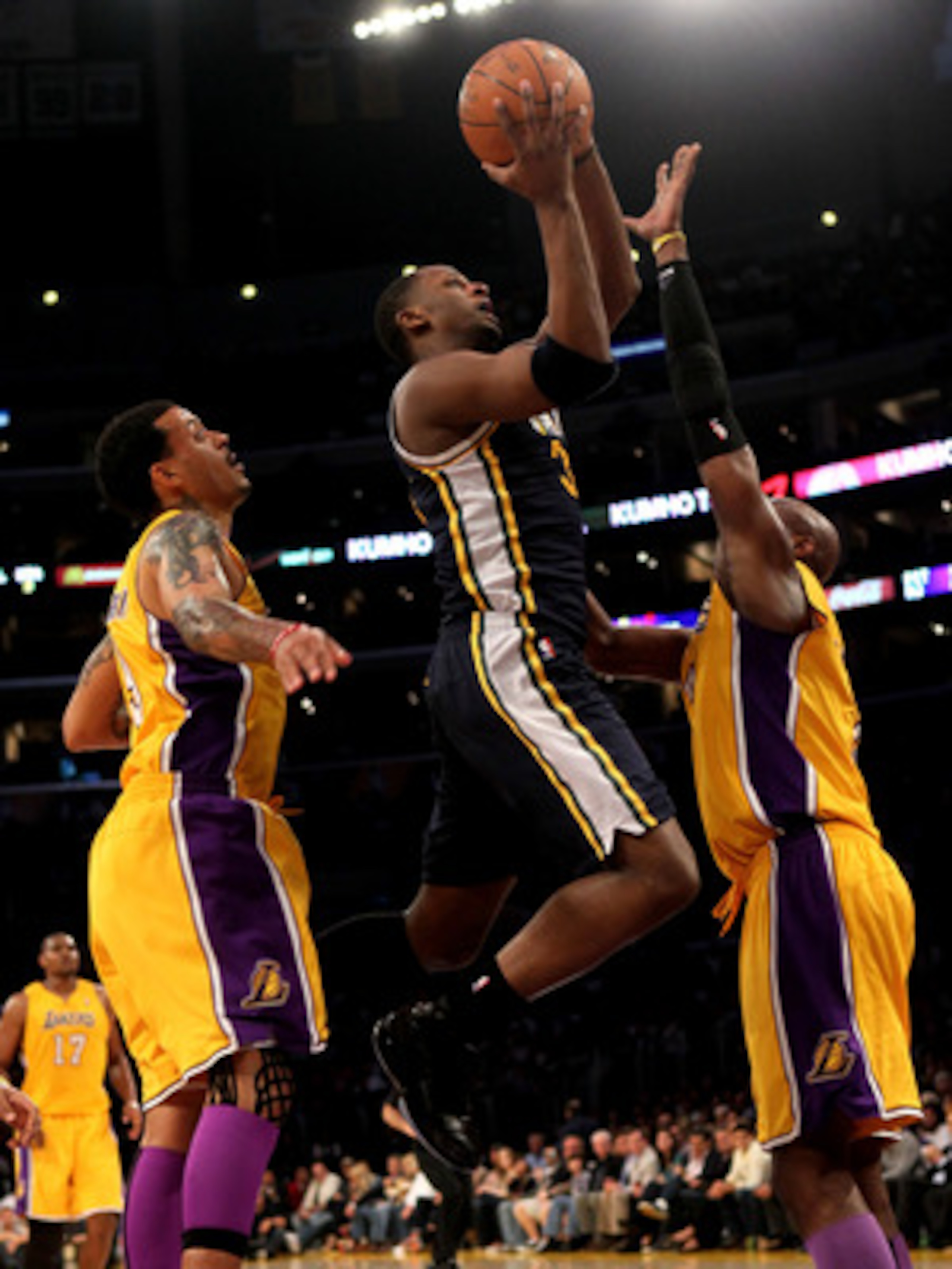 LOS ANGELES, CA - APRIL 05:  C.J. Miles #34 of the Utah Jazz shoots over Kobe Bryant #24 and Matt Barnes #9 of the Los Angeles Lakers at Staples Center on April 5, 2011 in Los Angeles, California. The Jazz won 86-85.  NOTE TO USER: User expressly acknowle