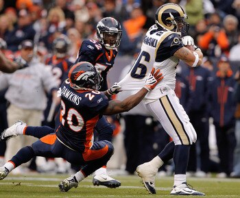 DENVER - NOVEMBER 28:  Tight end Michael Hoomanawanui #86 of the St. Louis Rams breaks away from safety Brian Dawkins #20 and Perrish Cox #32 of the Denver Broncos on his way to scoring a 36-yard touchdown in the first quarter at INVESCO Field at Mile Hig