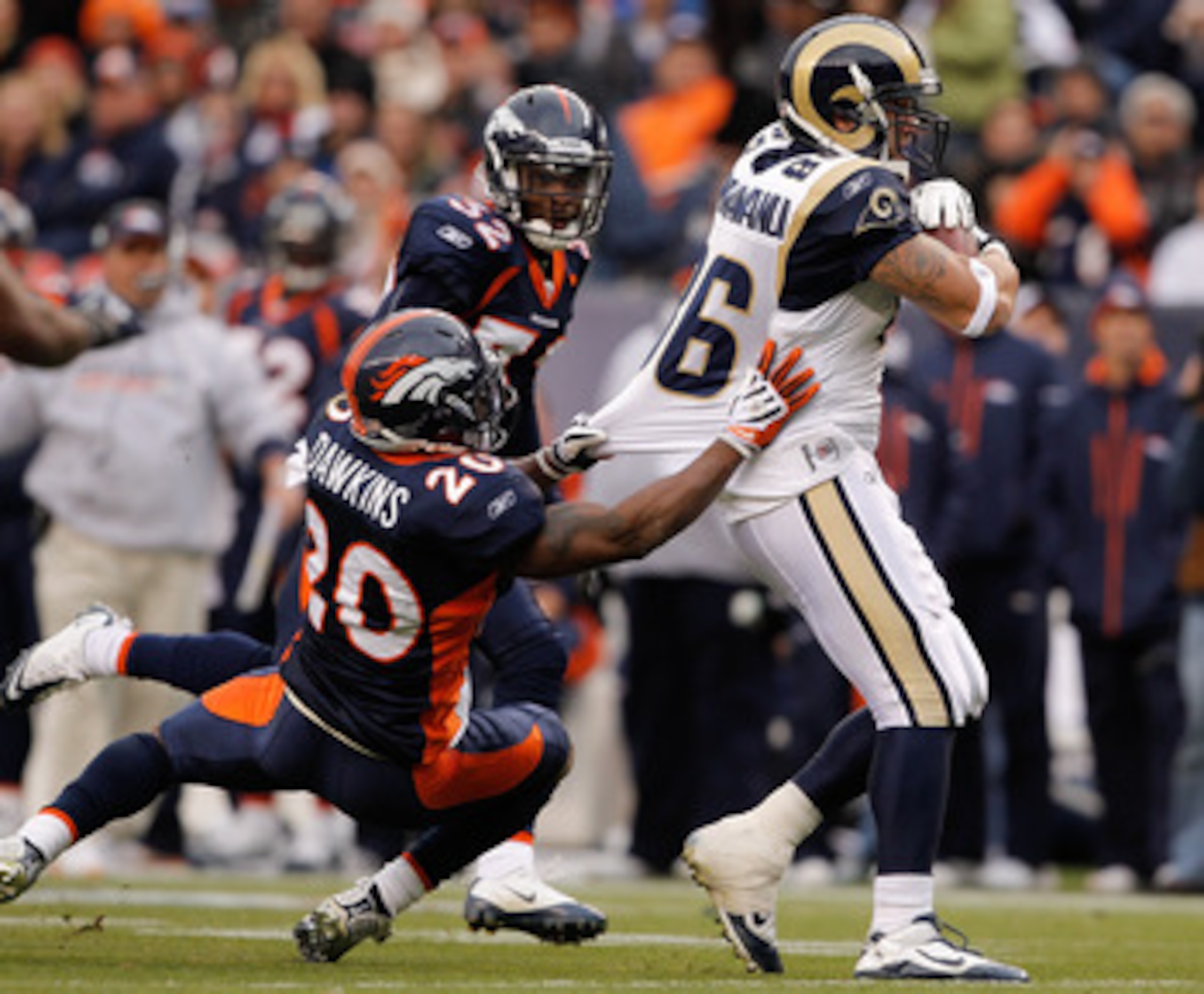 DENVER - NOVEMBER 28:  Tight end Michael Hoomanawanui #86 of the St. Louis Rams breaks away from safety Brian Dawkins #20 and Perrish Cox #32 of the Denver Broncos on his way to scoring a 36-yard touchdown in the first quarter at INVESCO Field at Mile Hig