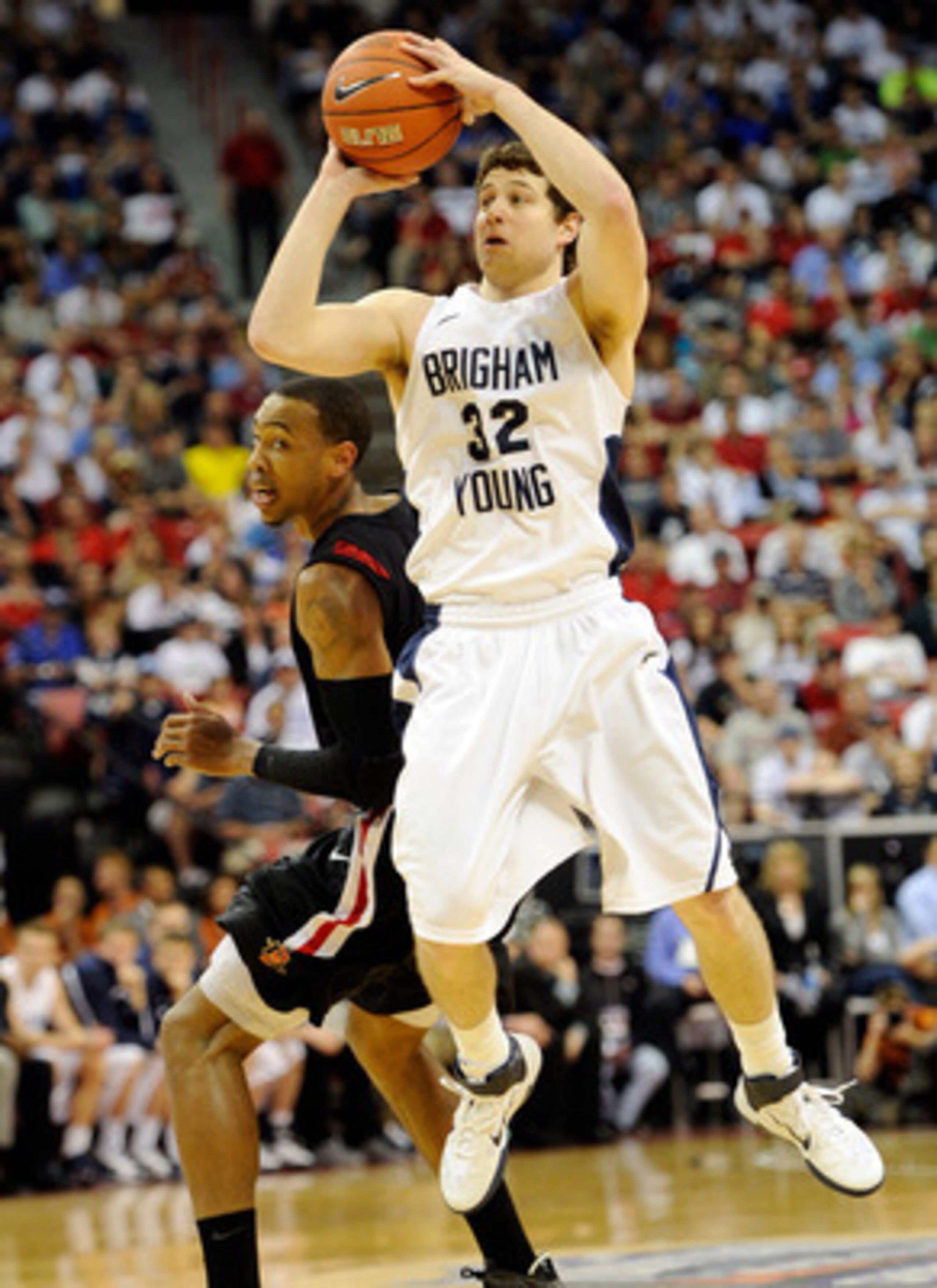LAS VEGAS, NV - MARCH 12:  Jimmer Fredette #32 of the Brigham Young University Cougars shoots against Malcolm Thomas #4 of the San Diego State Aztecs during the championship game of the Conoco Mountain West Conference Basketball tournament at the Thomas &