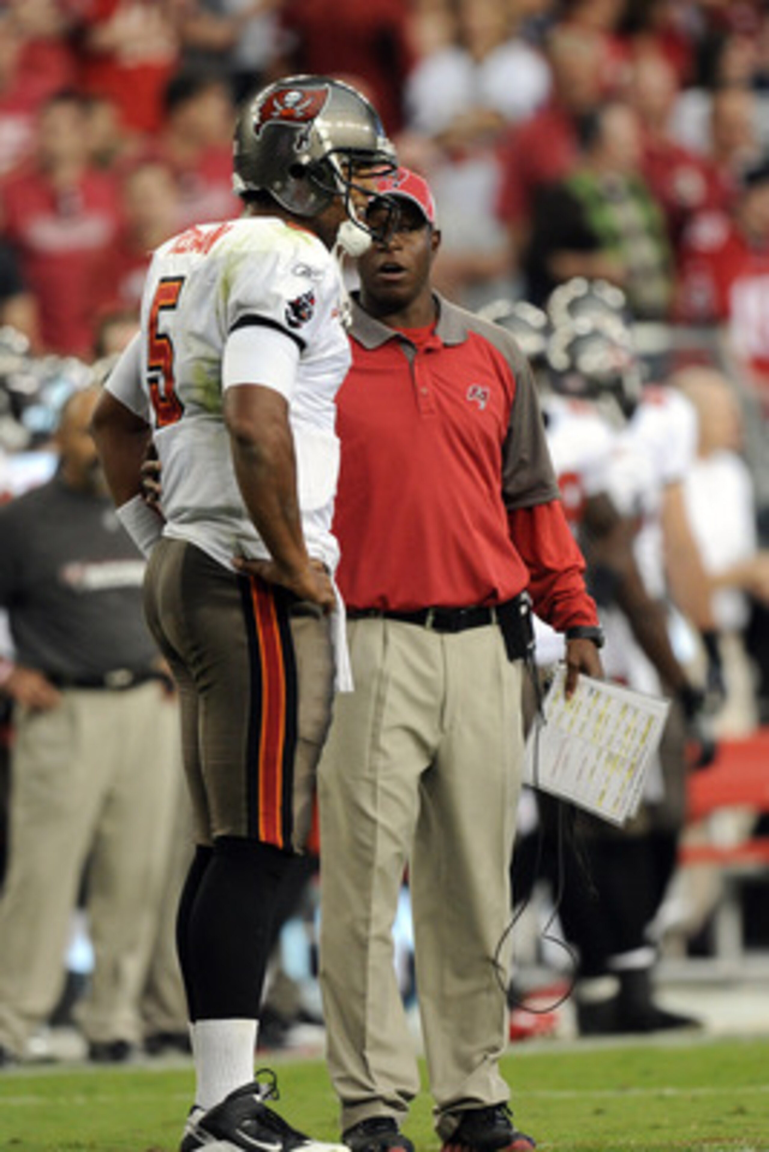 GLENDALE, AZ - OCTOBER 31:  Josh Freeman #5 of the Tampa Bay Buccaneers speaks to Head Coach Raheem Morris during a timeout against the Arizona Cardinals at University of Phoenix Stadium on October 31, 2010 in Glendale, Arizona.  (Photo by Harry How/Getty
