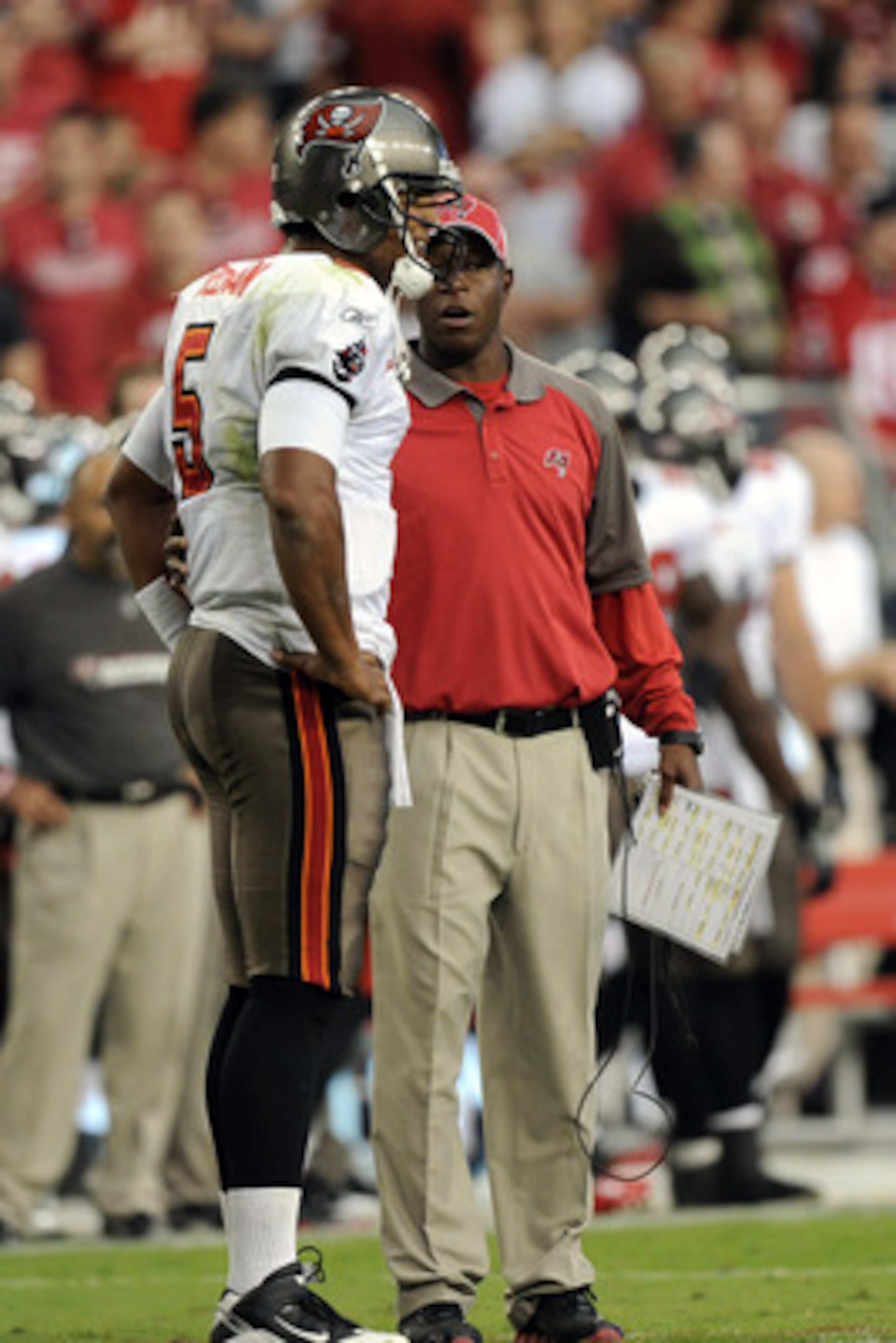 GLENDALE, AZ - OCTOBER 31:  Josh Freeman #5 of the Tampa Bay Buccaneers speaks to Head Coach Raheem Morris during a timeout against the Arizona Cardinals at University of Phoenix Stadium on October 31, 2010 in Glendale, Arizona.  (Photo by Harry How/Getty