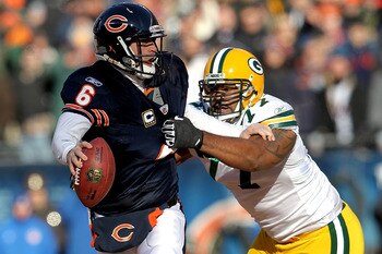 CHICAGO, IL - JANUARY 23:  Quarterback Jay Cutler #6 of the Chicago Bears attempts to avoid a sack by Cullen Jenkins #77 of the Green Bay Packers in the first quarter of the NFC Championship Game at Soldier Field on January 23, 2011 in Chicago, Illinois.