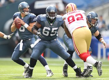 SEATTLE - SEPTEMBER 12:  Quarterback Matt Hasselbeck #8 of the Seattle Seahawks drops back to pass as Chris Spencer #65 and Ben Hamilton #50 defend against Aubrayo Franklin #92 of the San Francisco 49ers during the NFL season opener against at Qwest Field