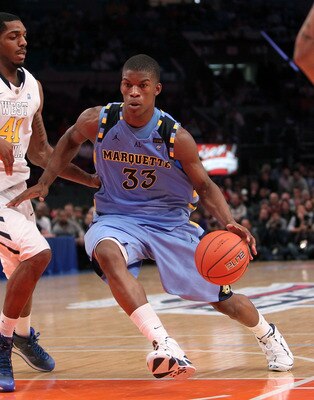 NEW YORK, NY - MARCH 09: Jimmy Butler #33 of the Marquette Golden Eagles drives with the ball against John Flowers #41 of the West Virginia Mountaineers during the second round of the 2011 Big East Men's Basketball Tournament presented by American Eagle O