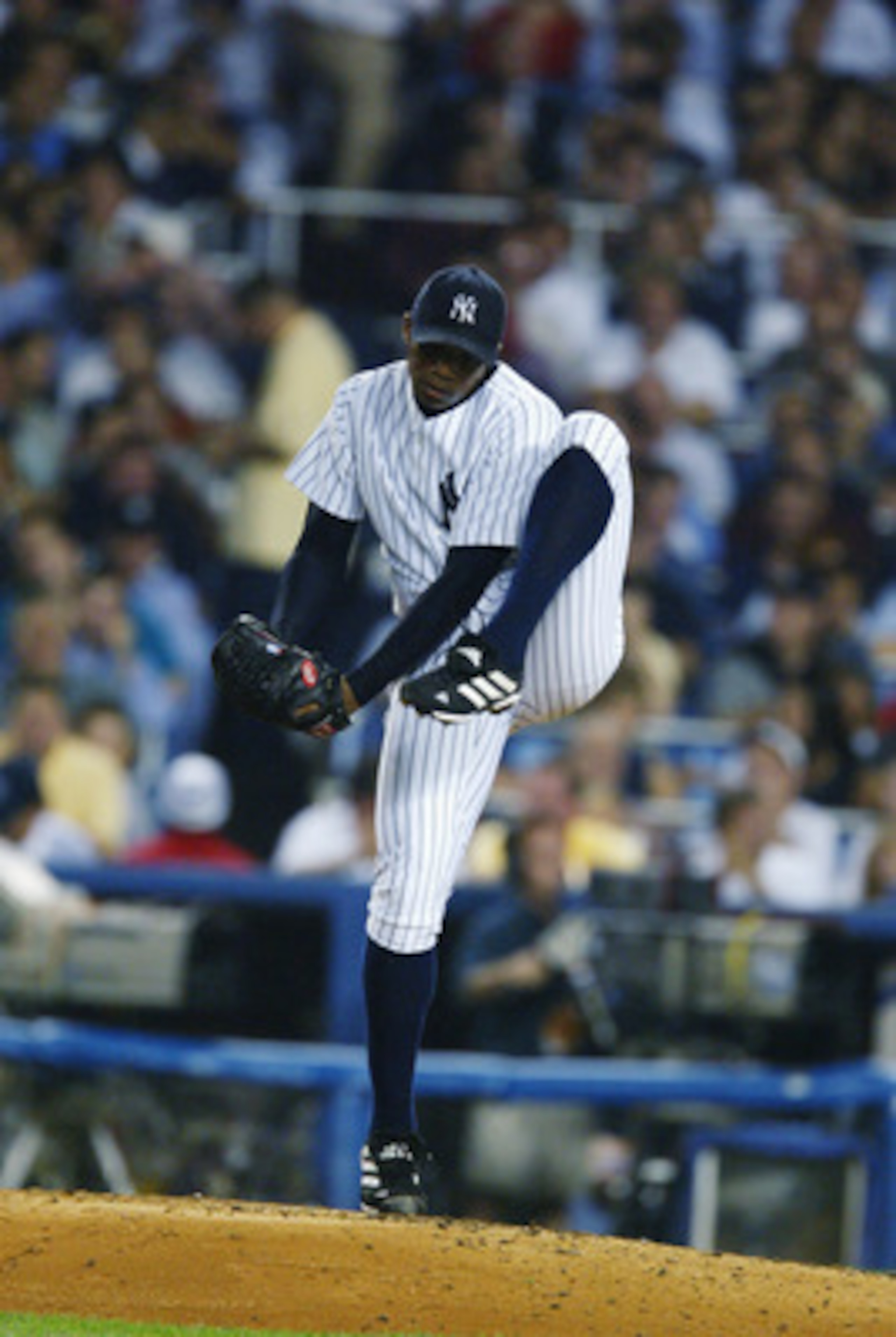 BRONX, NY - OCTOBER 2:   Orlando Hernandez #26 of the New York Yankees winds up the pitch during game two of the American League Division Series against the Anaheim Angels at Yankee Stadium in the Bronx, New York on October 2, 2002.  The Angels defeated t