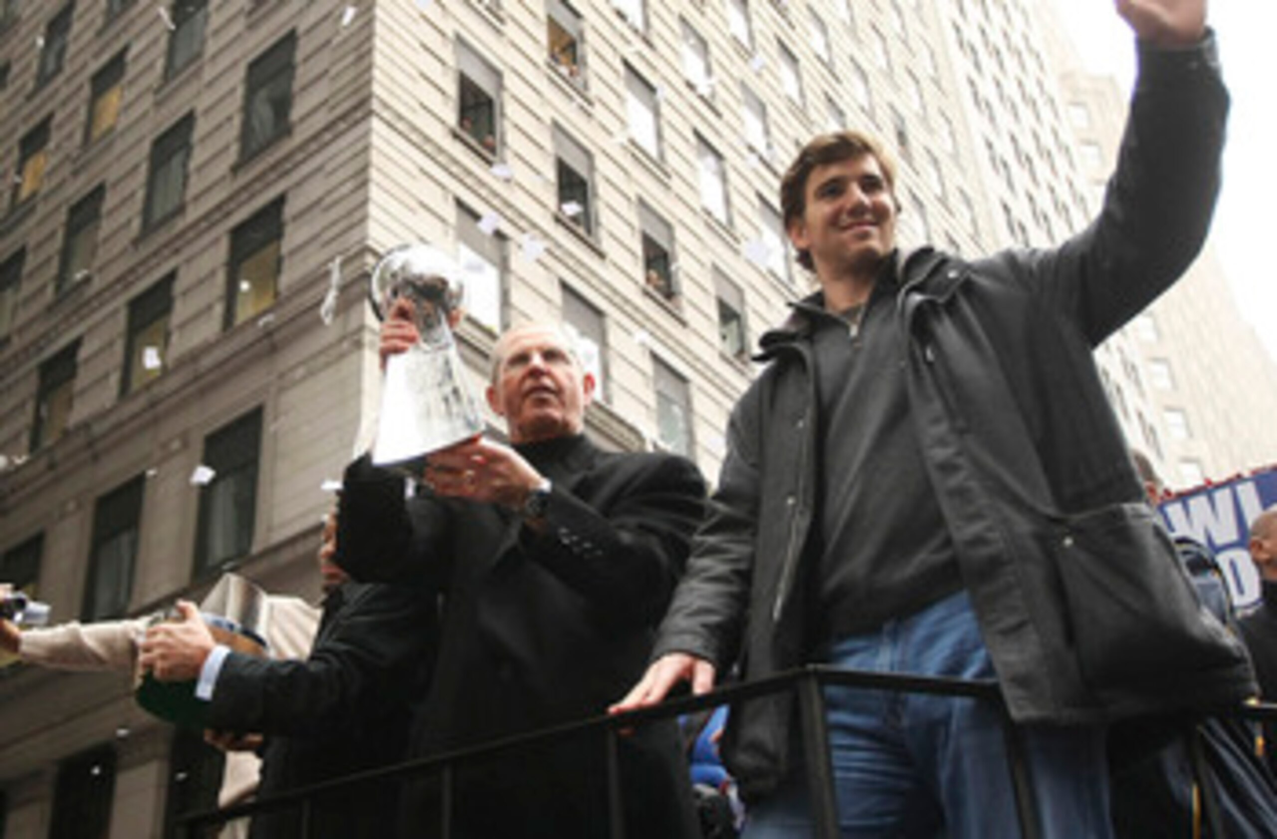 NEW YORK - FEBRUARY 05:  New York Giants coach Tom Coughlin (L) and quarterback Eli Manning wave to fans during the New York Giants Superbowl XLII victory parade February 5, 2008 in New York City.  (Photo by Chris McGrath/Getty Images)