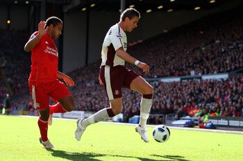 LIVERPOOL, ENGLAND - SEPTEMBER 25: Jordan Henderson of Sunderland ín action with Glen  Johnson of Liverpool during the Barclays Premier League match between Liverpool and Sunderland at at Anfield on September 25, 2010 in Liverpool, England.  (Photo by Cli