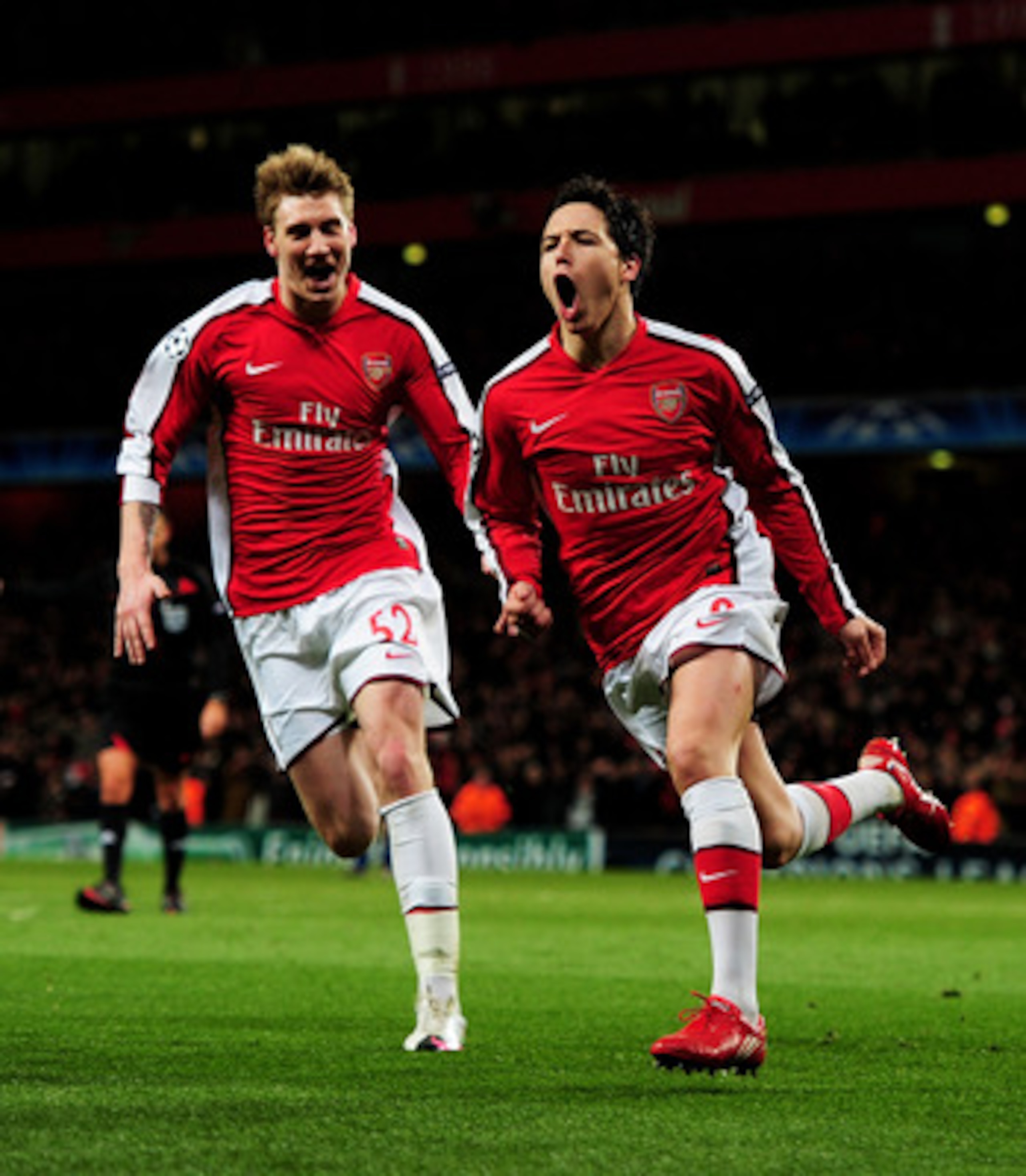 LONDON, ENGLAND - MARCH 09:  Samir Nasri (R) of Arsenal celebrates with teammate Nicklas Bendtner after scoring his team's third goal during the UEFA Champions League round of 16 match between Arsenal and FC Porto at the Emirates Stadium on March 9, 2010