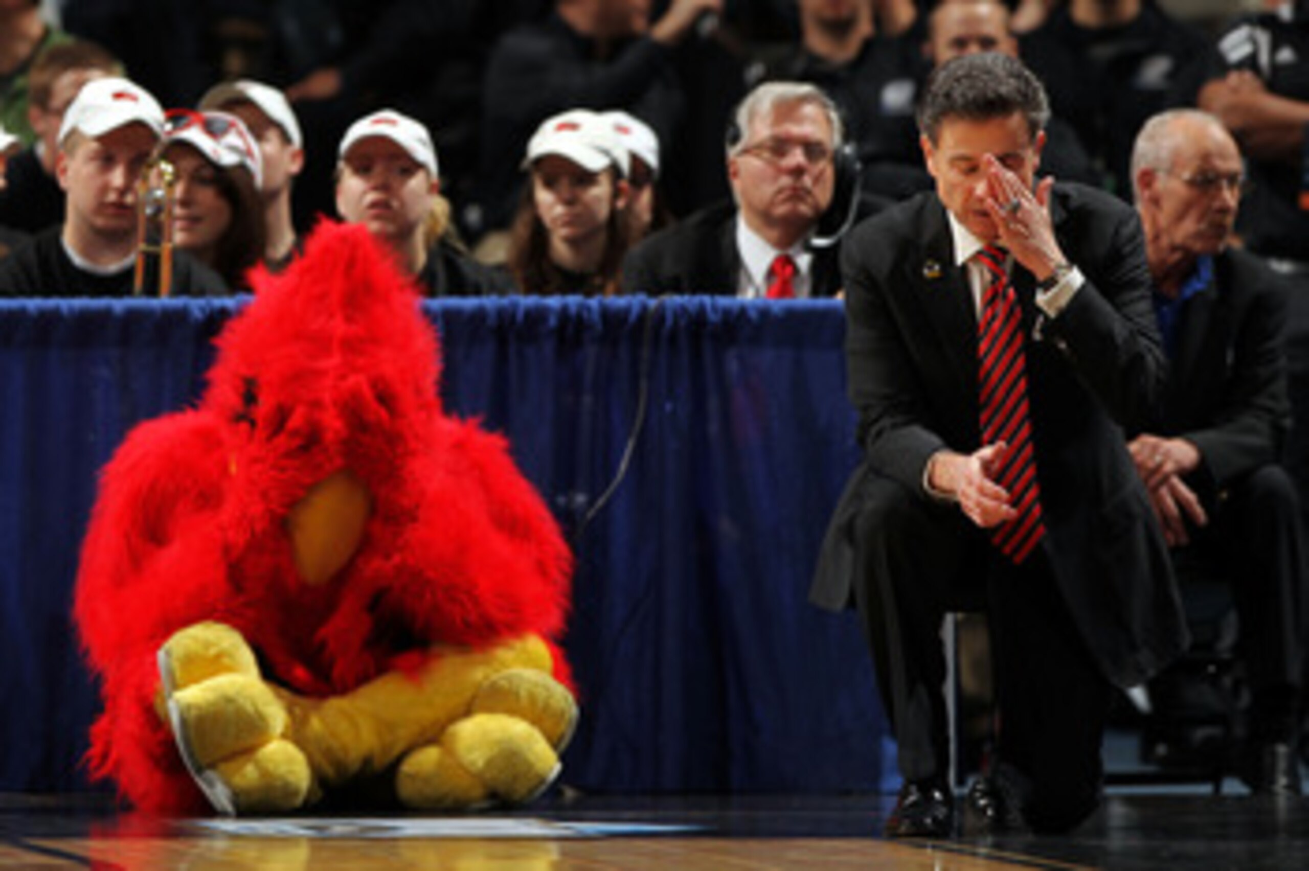 DENVER, CO - MARCH 17:  Head coach Rick Pitino of the Louisville Cardinals and the teams mascot react after a play while playing against the Morehead State Eagles during the second round of the 2011 NCAA men's basketball tournament at Pepsi Center on Marc