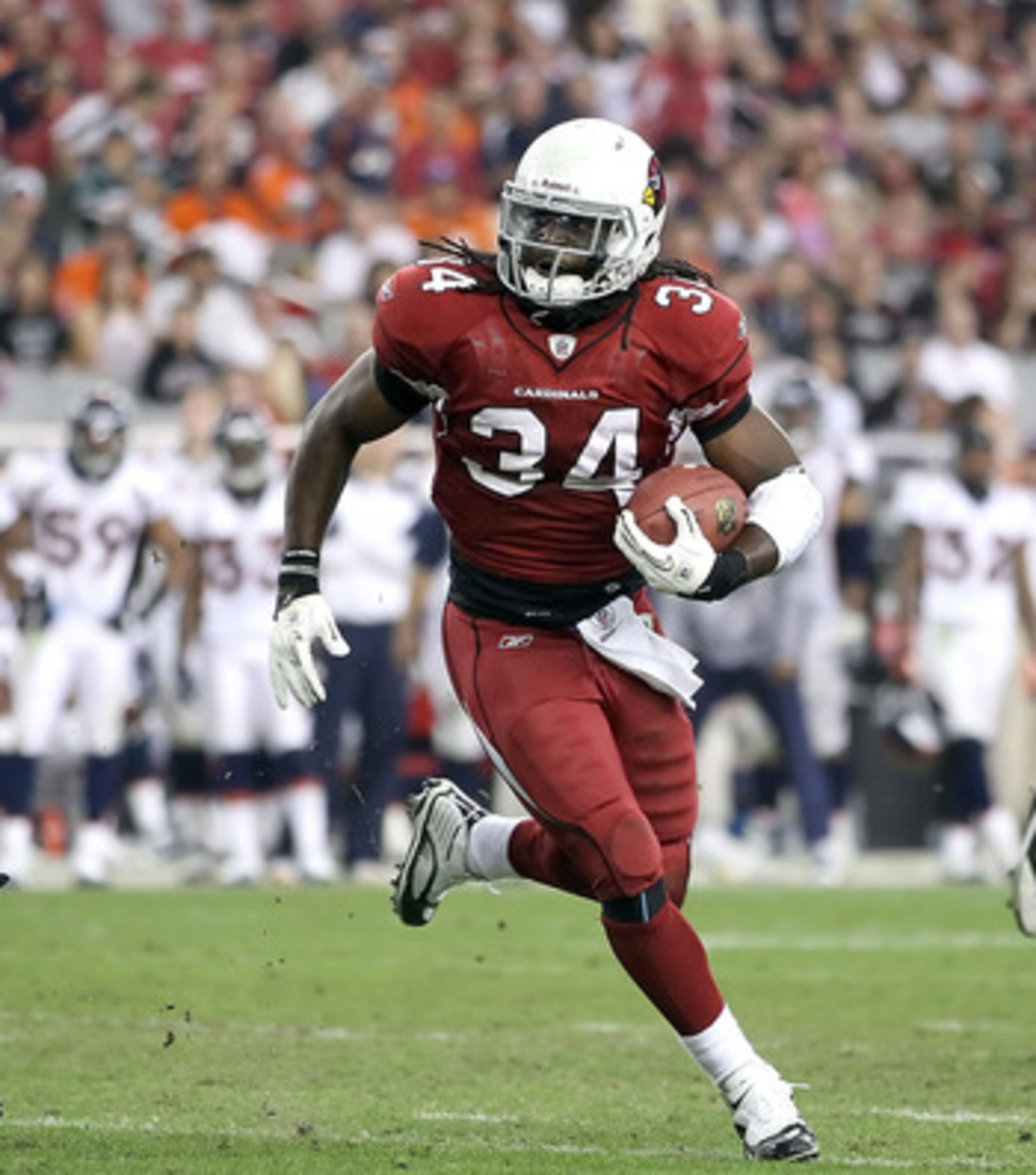 GLENDALE, AZ - DECEMBER 12:  Runningback Tim Hightower #34 of the Arizona Cardinals rushes the football against the Denver Broncos during the NFL game at the University of Phoenix Stadium on December 12, 2010 in Glendale, Arizona.  (Photo by Christian Pet