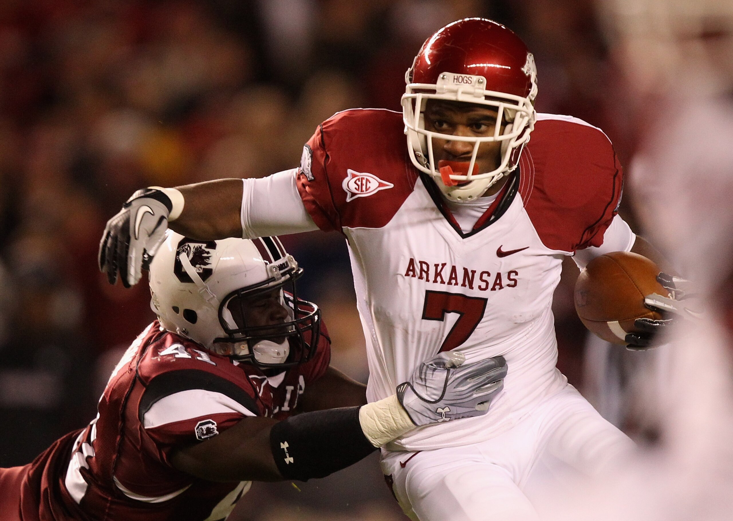 COLUMBIA, SC - NOVEMBER 06:  Knile Davis #7 of the Arkansas Razorbacks pushes away from Josh Dickerson #41 of the South Carolina Gamecocks during their game at Williams-Brice Stadium on November 6, 2010 in Columbia, South Carolina.  (Photo by Streeter Lec