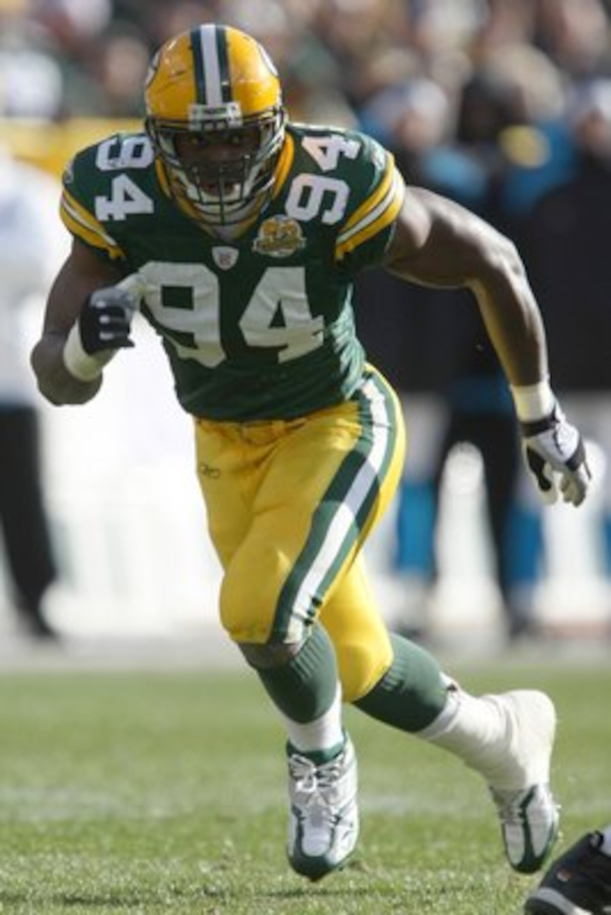 GREEN BAY - NOVEMBER 18: Kabeer Gbaja-Biamila #94 of the Green Bay Packers runs during the NFL game against the Carolina Panthers at Lambeau Field on November 18, 2007 in Green Bay, Wisconsin. (Photo by Jonathan Daniel/Getty Images) GREEN BAY - NOVEMBER 18: Kabeer Gbaja-Biamila #94 of the Green Bay Packers runs during the NFL game against the Carolina Panthers at Lambeau Field on November 18, 2007 in Green Bay, Wisconsin. (Photo by Jonathan Daniel/Getty Images)